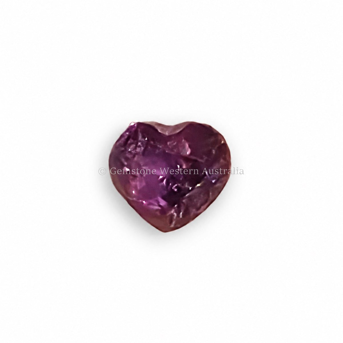 0.58 ct alexandrite under warm light showing its colour change