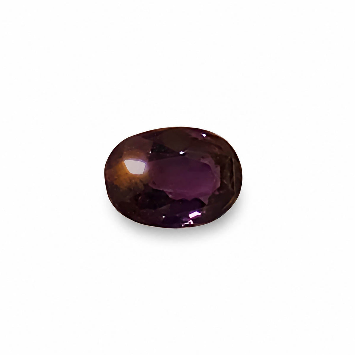 0.75 ct alexandrite under warm light showing its colour change