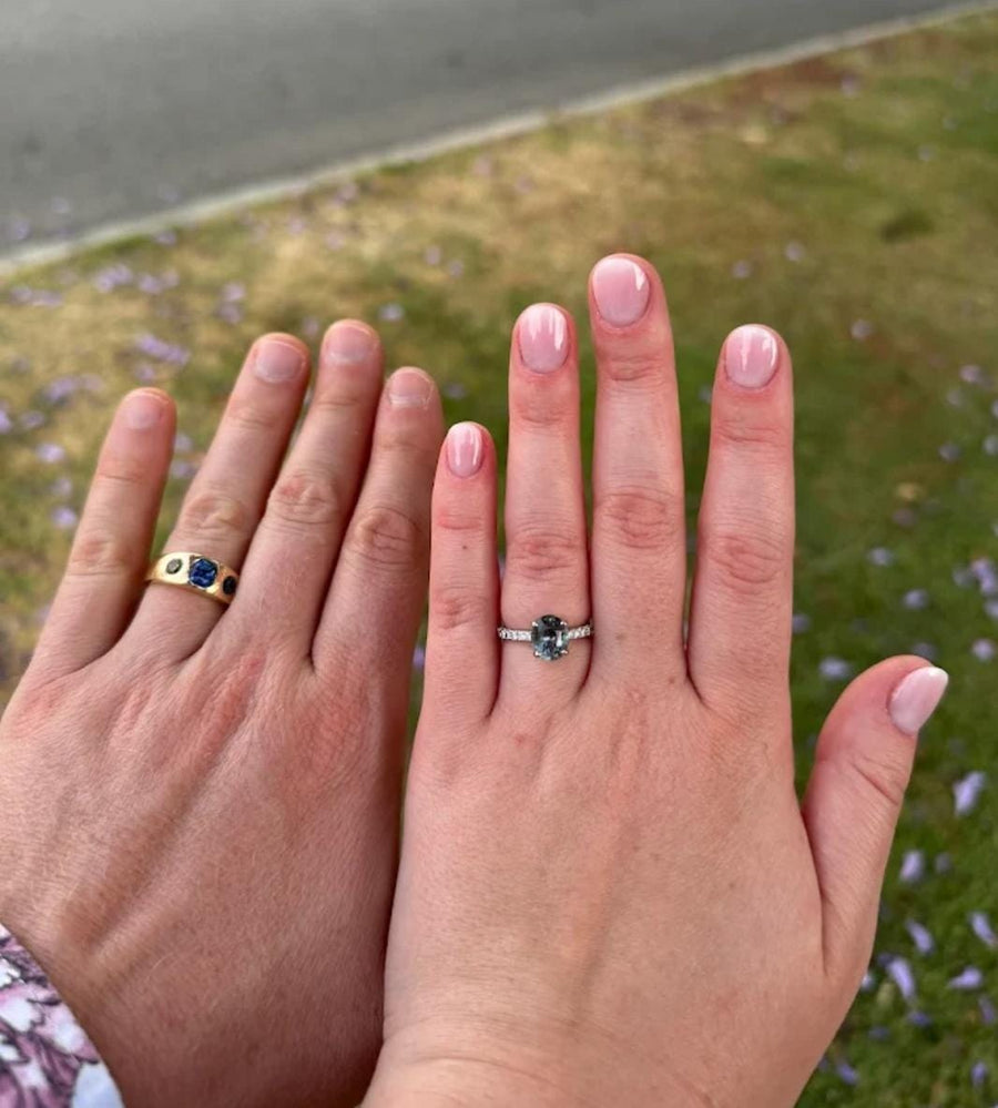 Engaged Couple Holding a Sapphire Engagement Ring