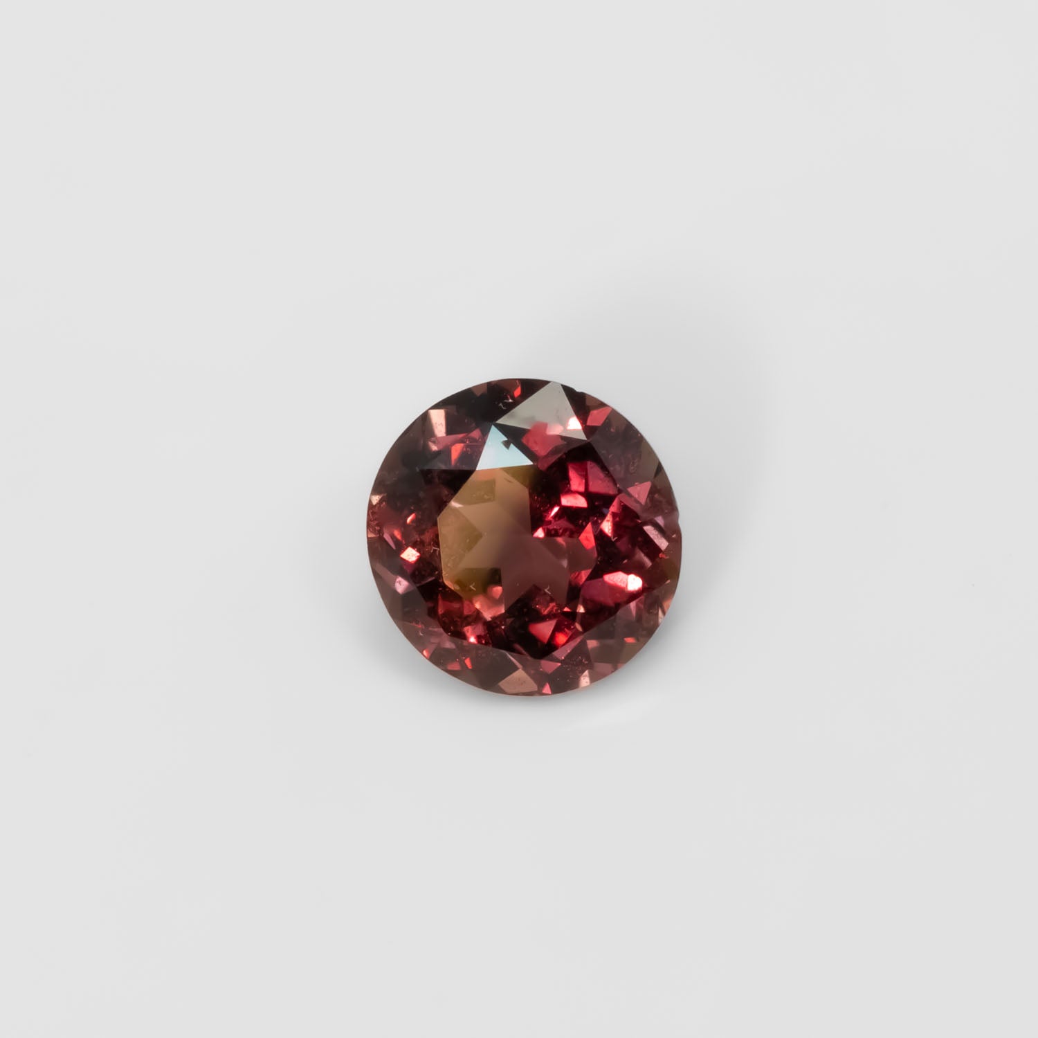 Front view of 1.89CT Natural Unheated Colour Change Brown-Red Sapphire – Round Mixed Cut in white background.
