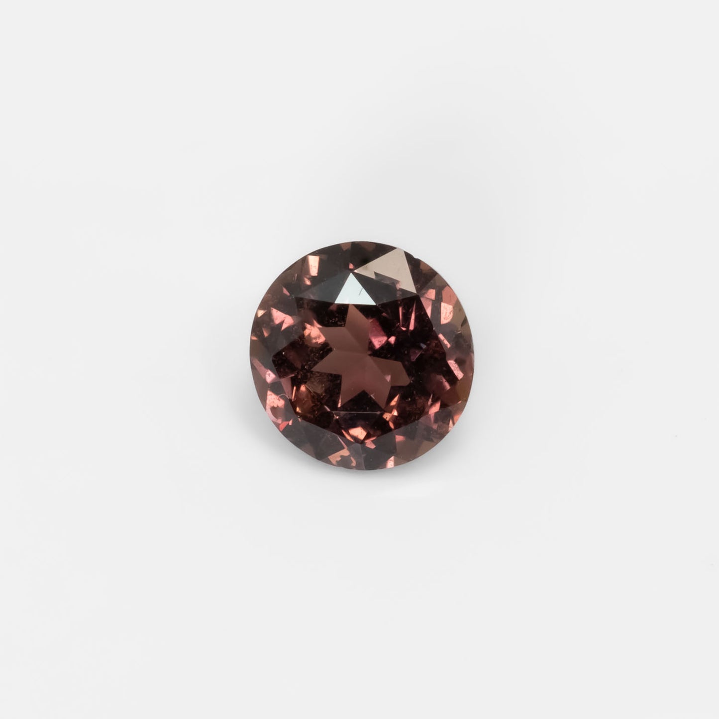 Front view of 1.89CT Natural Unheated Colour Change Brown-Red Sapphire – Round Mixed Cut in white background.