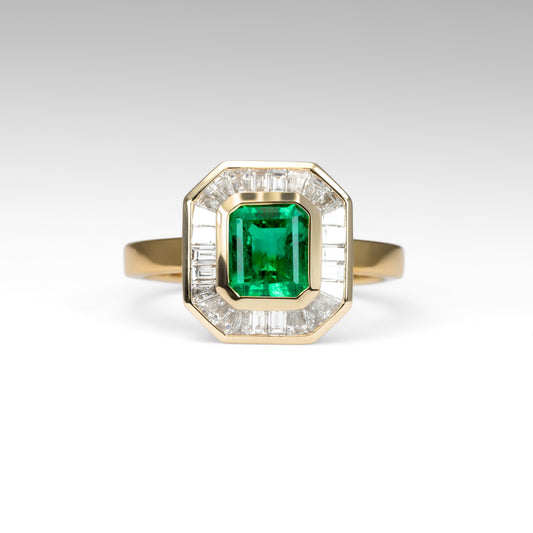 front view of Emerald Cut Colombian Emerald Ring with Baguette Diamond halo in white background