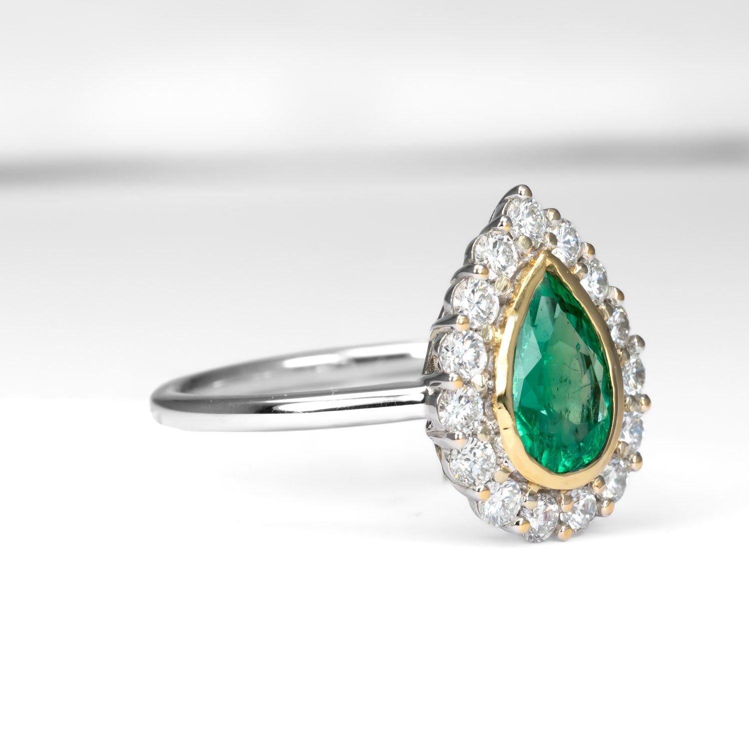 side view of Colombian Pear Emerald Halo Ring 1.17ct in 18K White & Yellow Gold in white background