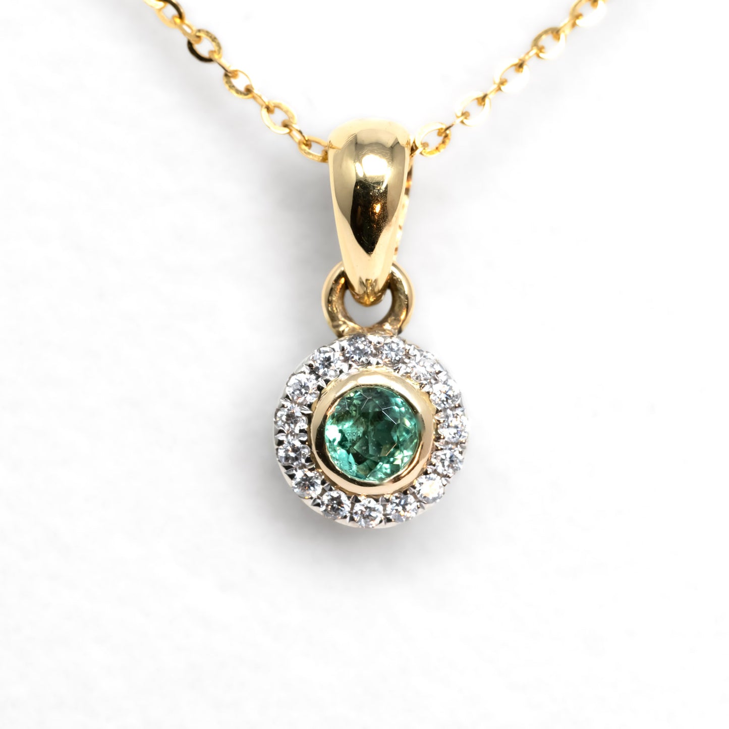 front view of Natural Colombian Emerald and Diamond Halo Pendant in white background