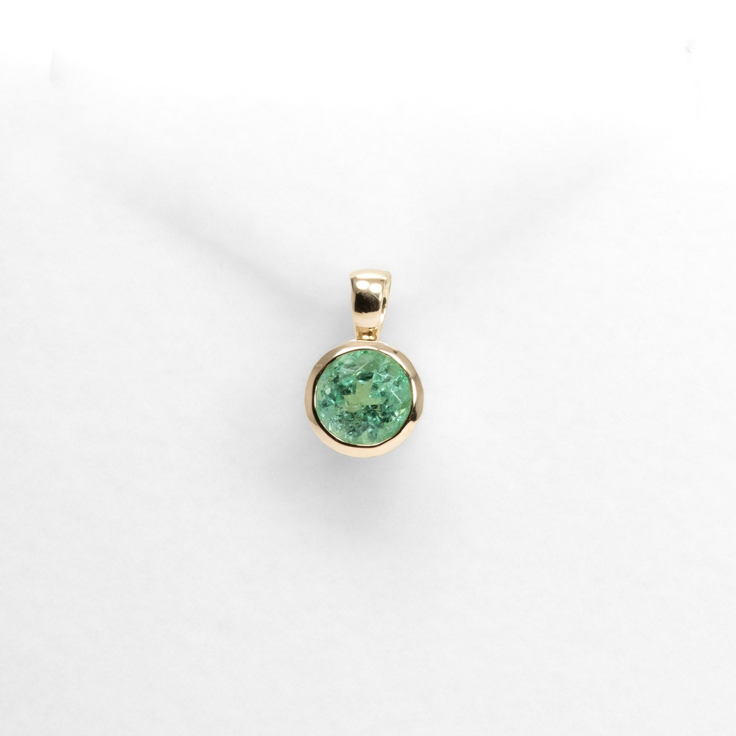 Colombian Emerald Bezel Set Pendant in 18K Yellow Gold in white background