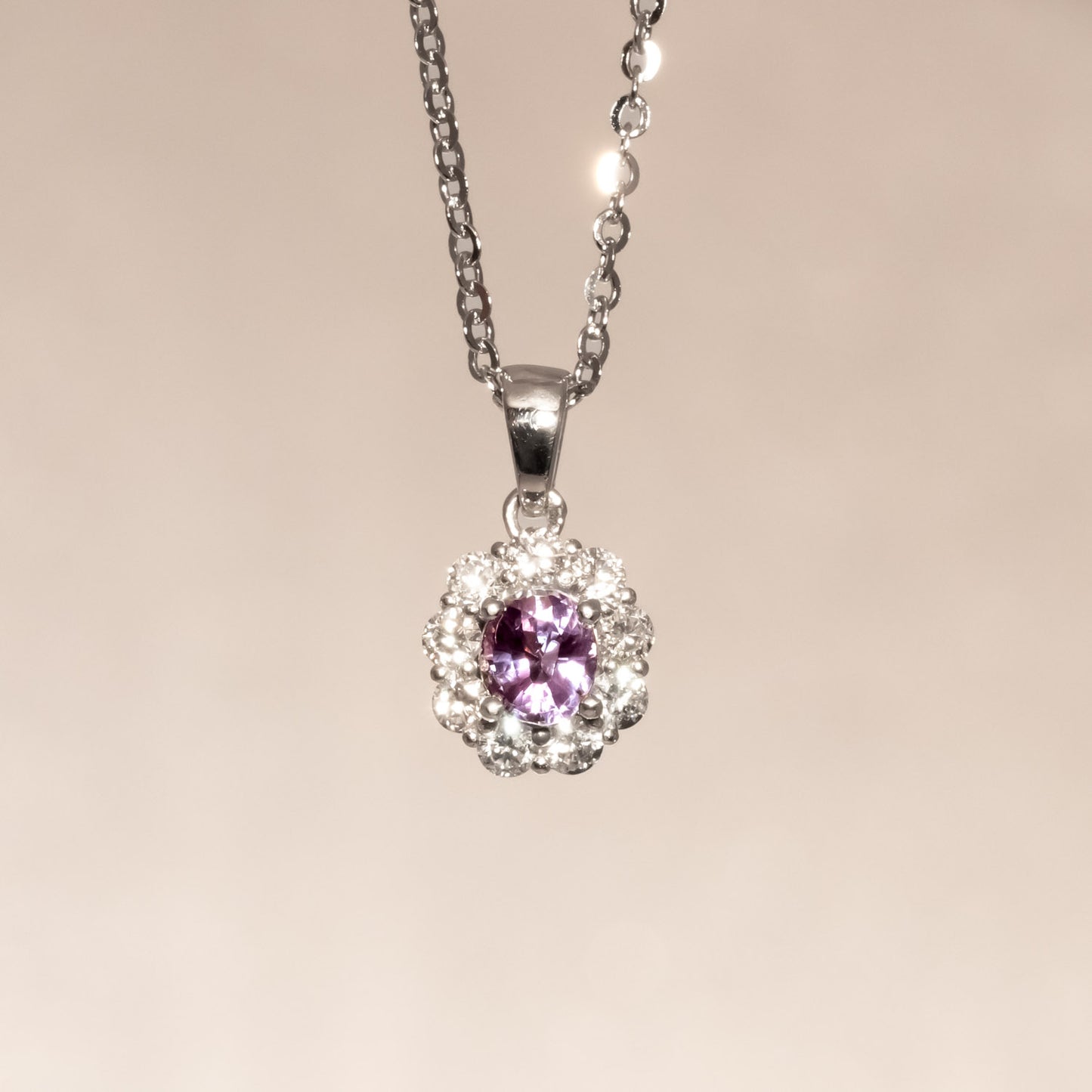 front view  under incandescent light of Natural Alexandrite Halo Pendant 0.43ct Oval Cut in Platinum 950 in neutral background