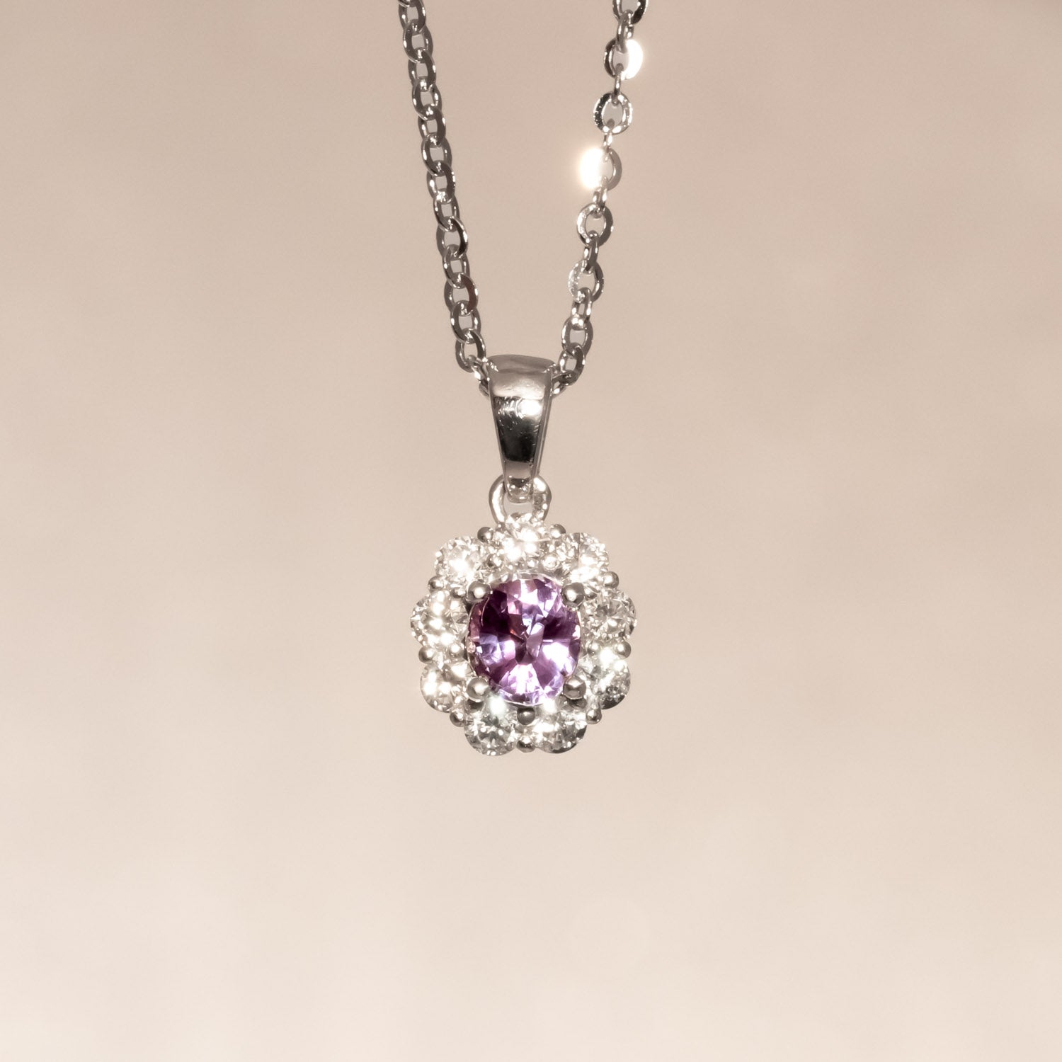 front view  under incandescent light of Natural Alexandrite Halo Pendant 0.43ct Oval Cut in Platinum 950 in neutral background