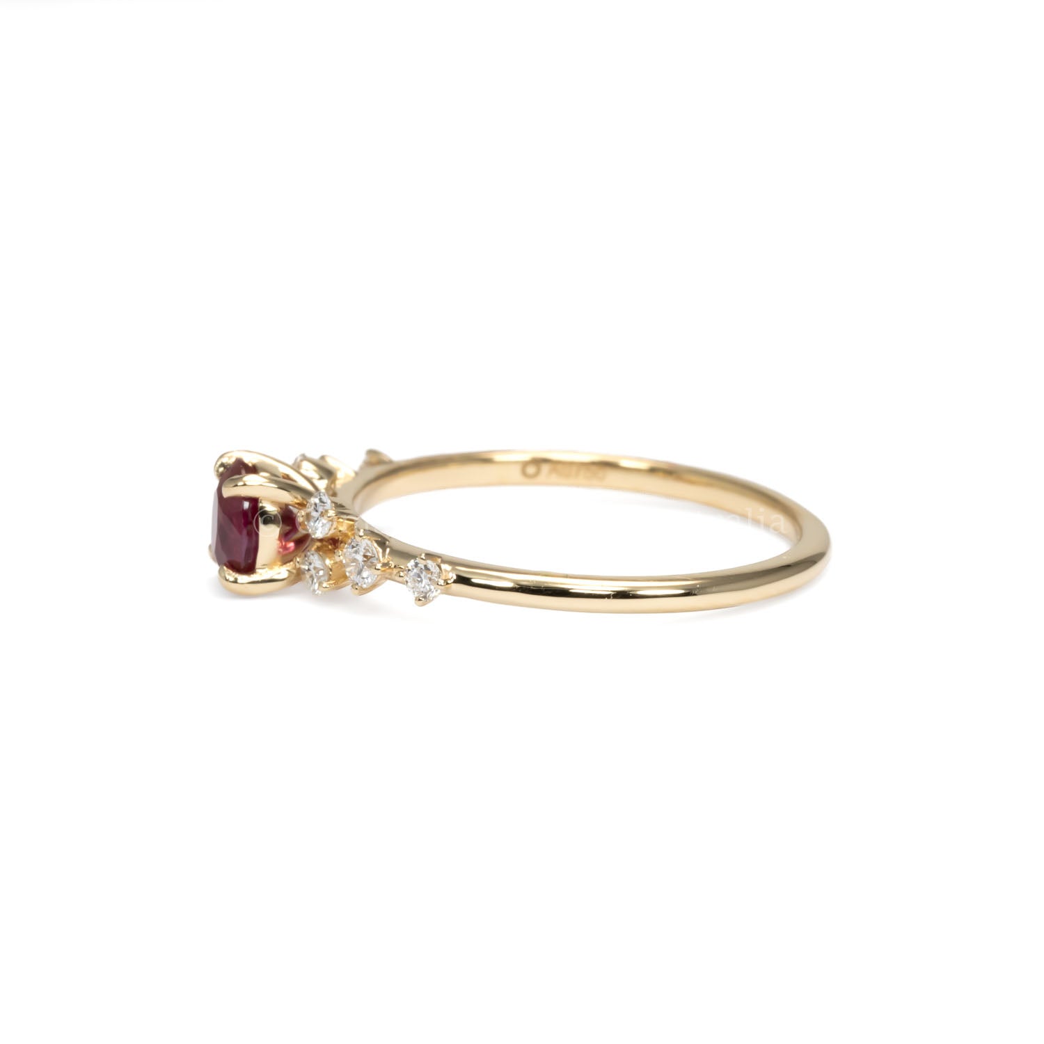 side view of ruby and diamonds gold ring in yellow gold in white background