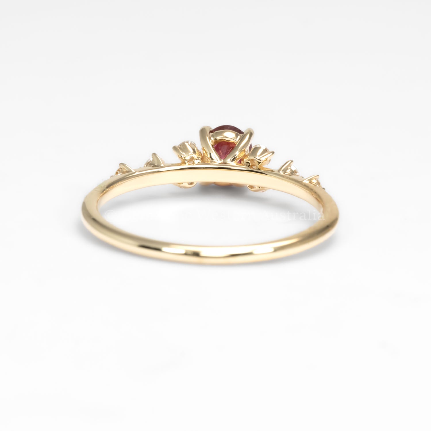 back view of ruby and diamonds gold ring in yellow gold in white background
