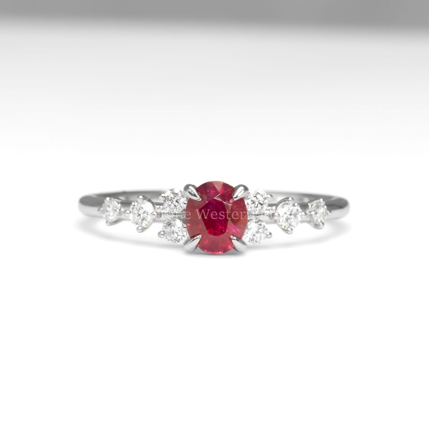 front view of natural ruby and diamond ring in platinum 950 in white background
