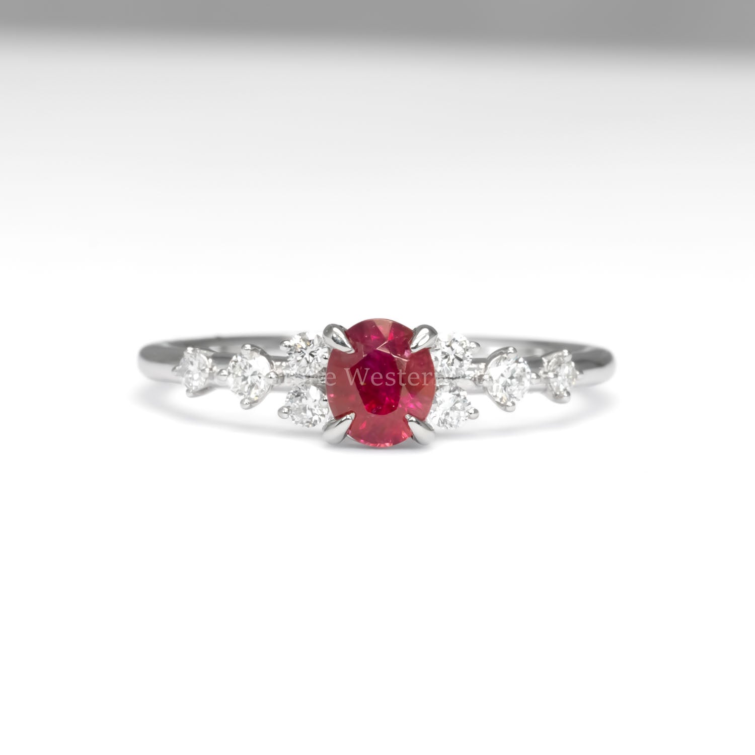 front view of natural ruby and diamond ring in platinum 950 in white background
