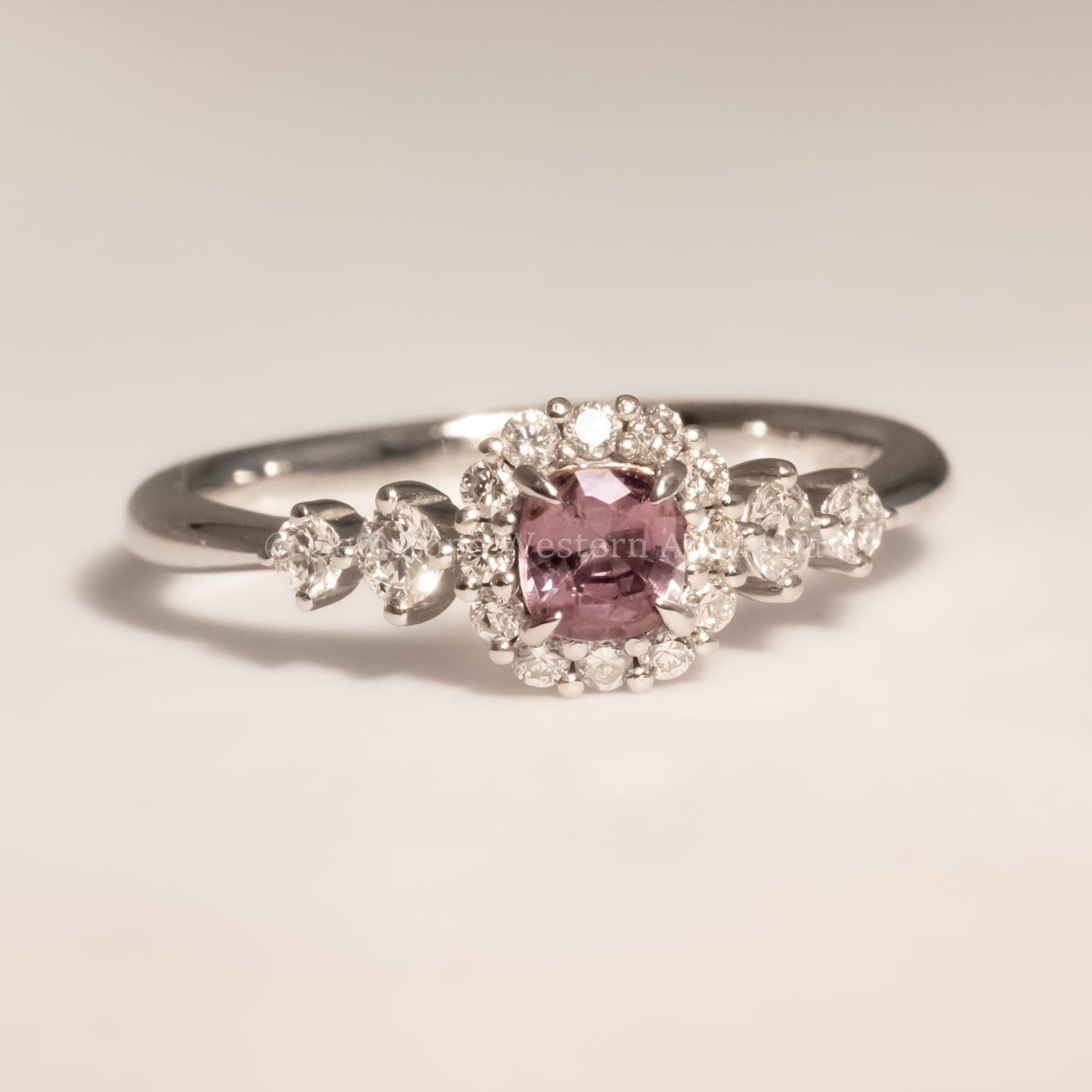 front view of Natural Alexandrite and Diamond Halo Ring in 18K Yellow Gold under incandescent 