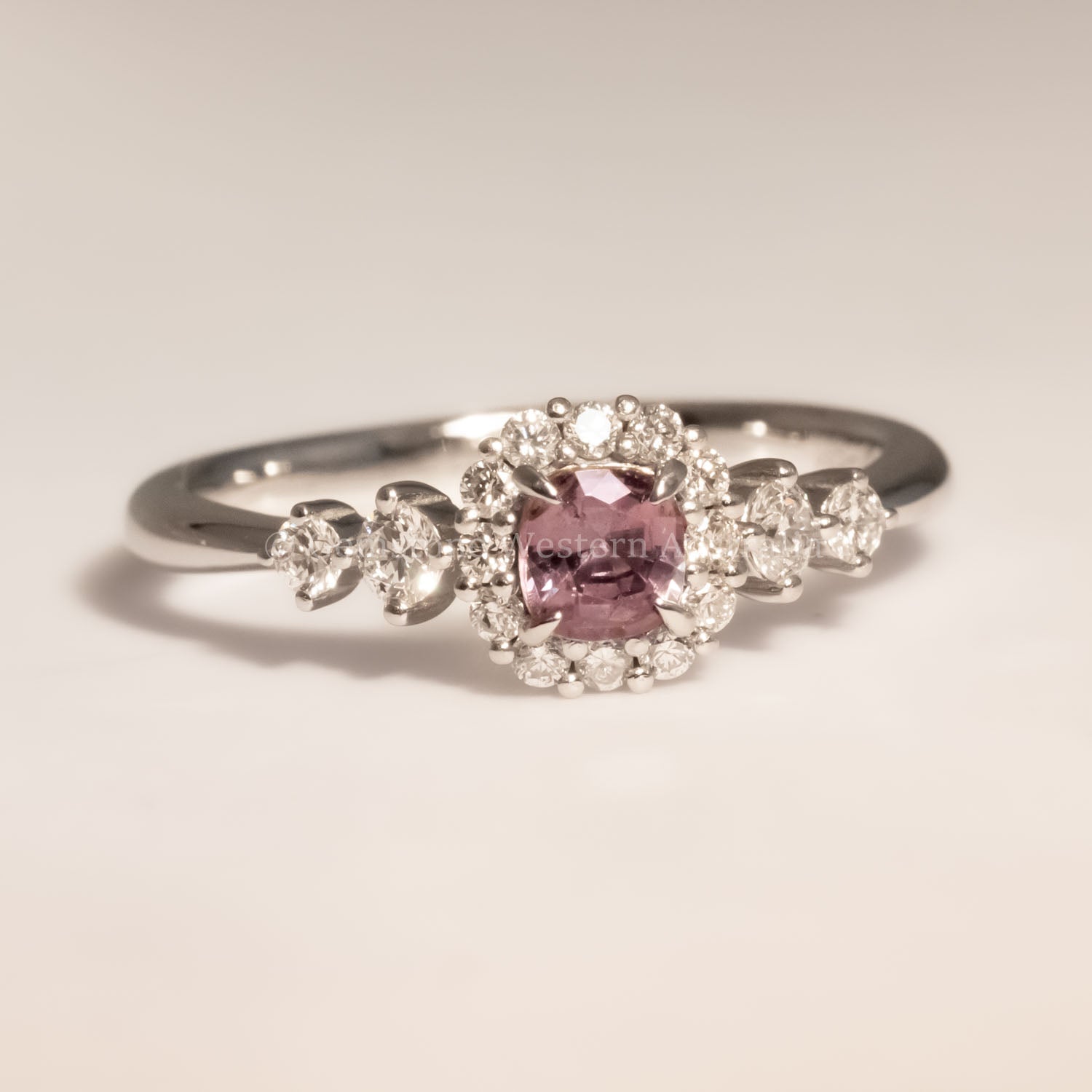 front view of Natural Alexandrite and Diamond Halo Ring in 18K Yellow Gold under incandescent 