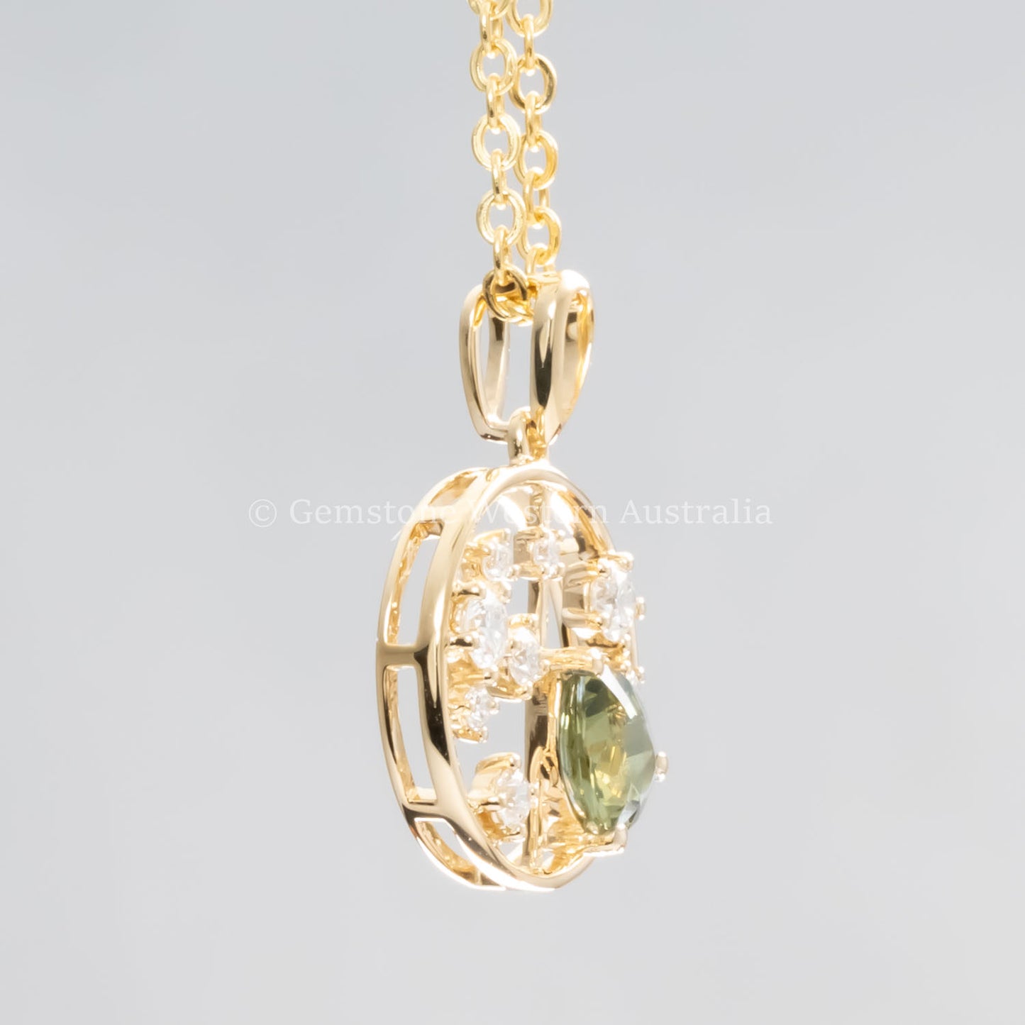 side view of Natural Alexandrite and Diamond Pendant in 18K Yellow Gold – 0.63ct Pear Cut in neutral background