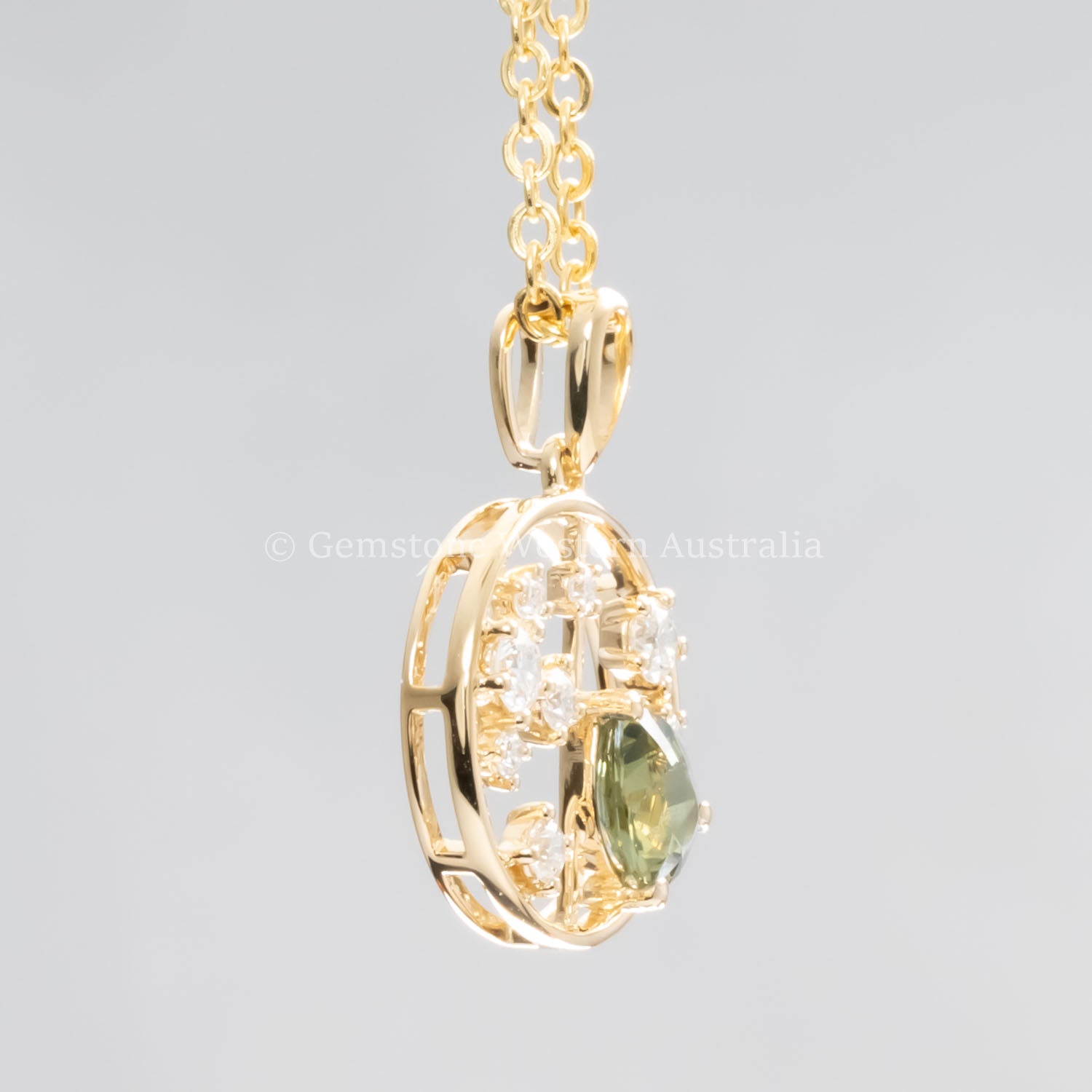 side view of Natural Alexandrite and Diamond Pendant in 18K Yellow Gold – 0.63ct Pear Cut in neutral background