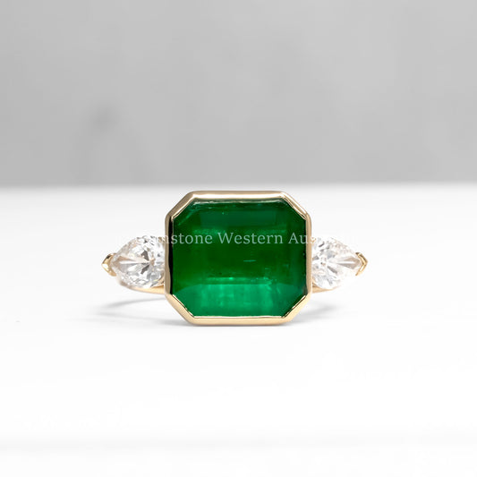 front view of Colombian Emerald and Diamond Ring in 18K Yellow Gold – East West Emerald Cut in white background