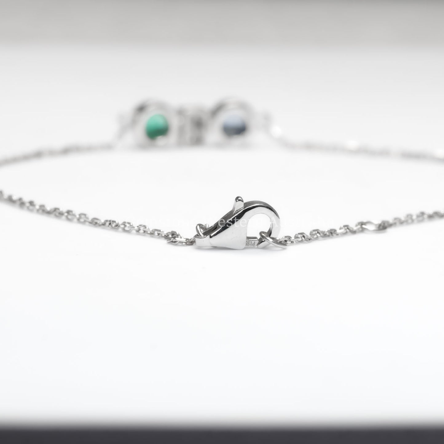 view of clasp in Colombian Emerald, Diamond and Blue Sapphire Bracelet in Platinum 950 in white background