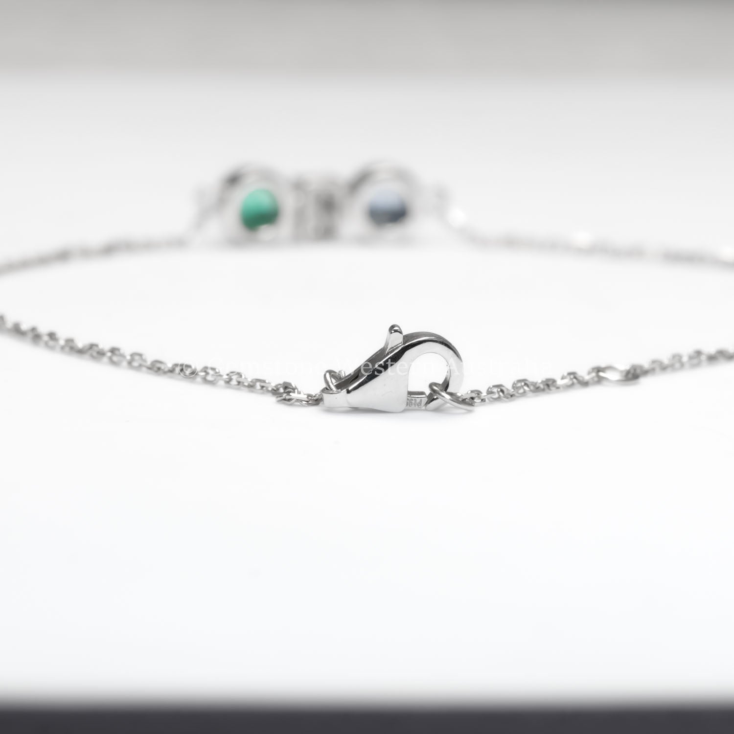 view of clasp in Colombian Emerald, Diamond and Blue Sapphire Bracelet in Platinum 950 in white background