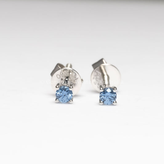 front view of Blue Sapphire Stud Earrings in Platinum – 2.5mm Round Cut in neutral background