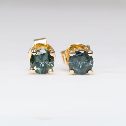 front view of round natural Australian teal sapphire studs in neutral background