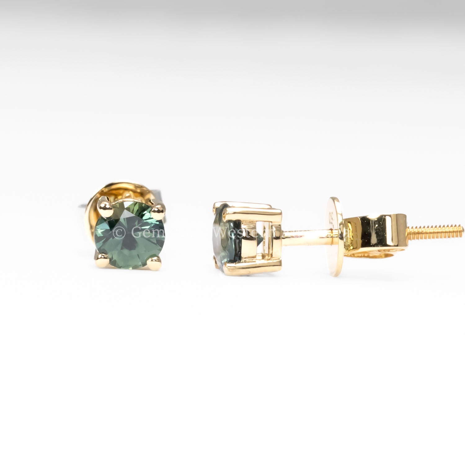 contrast of side and front view of round natural Australian teal sapphire studs in neutral background