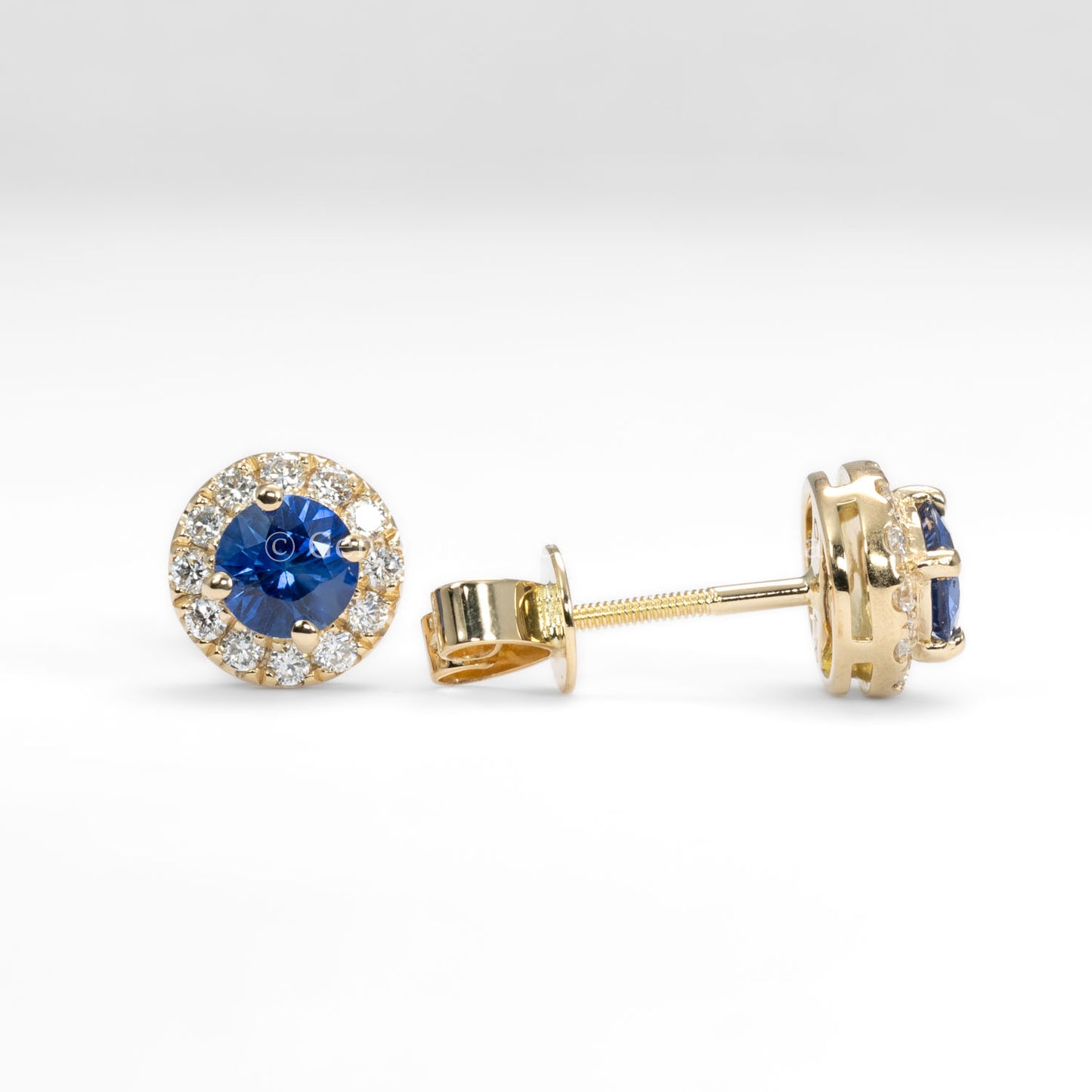 front and side view of Blue Sapphire and Diamond Halo Stud Earrings in 18K Yellow Gold in neutral background