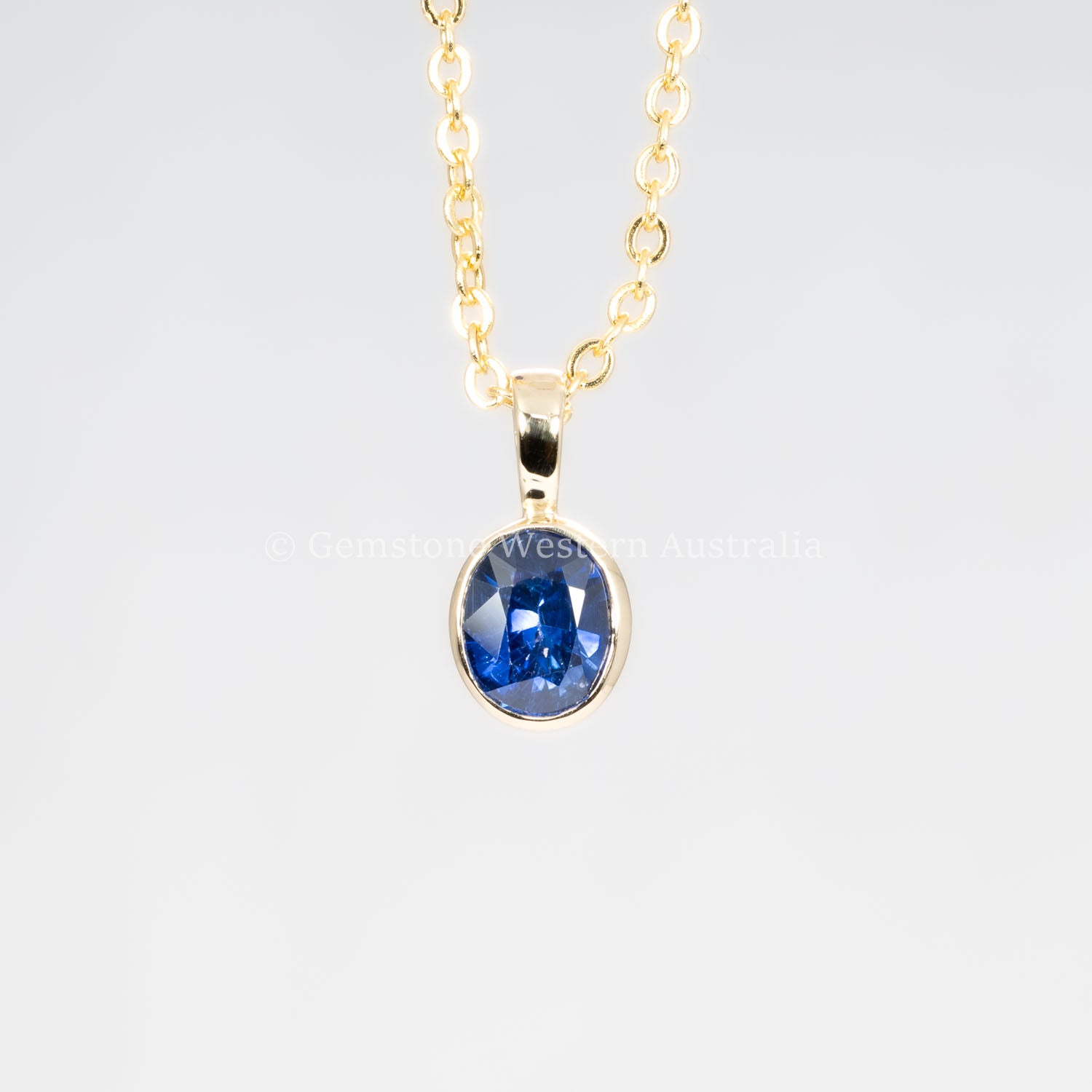 front view of Royal Blue Sapphire Pendant in 18K Yellow Gold in neutral background