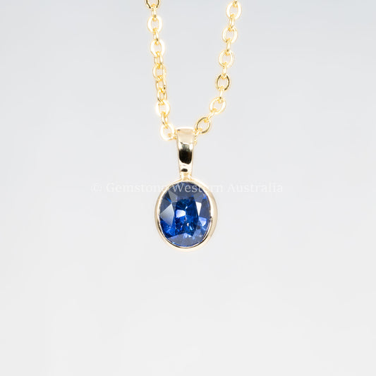 front view of Royal Blue Sapphire Pendant in 18K Yellow Gold in neutral background