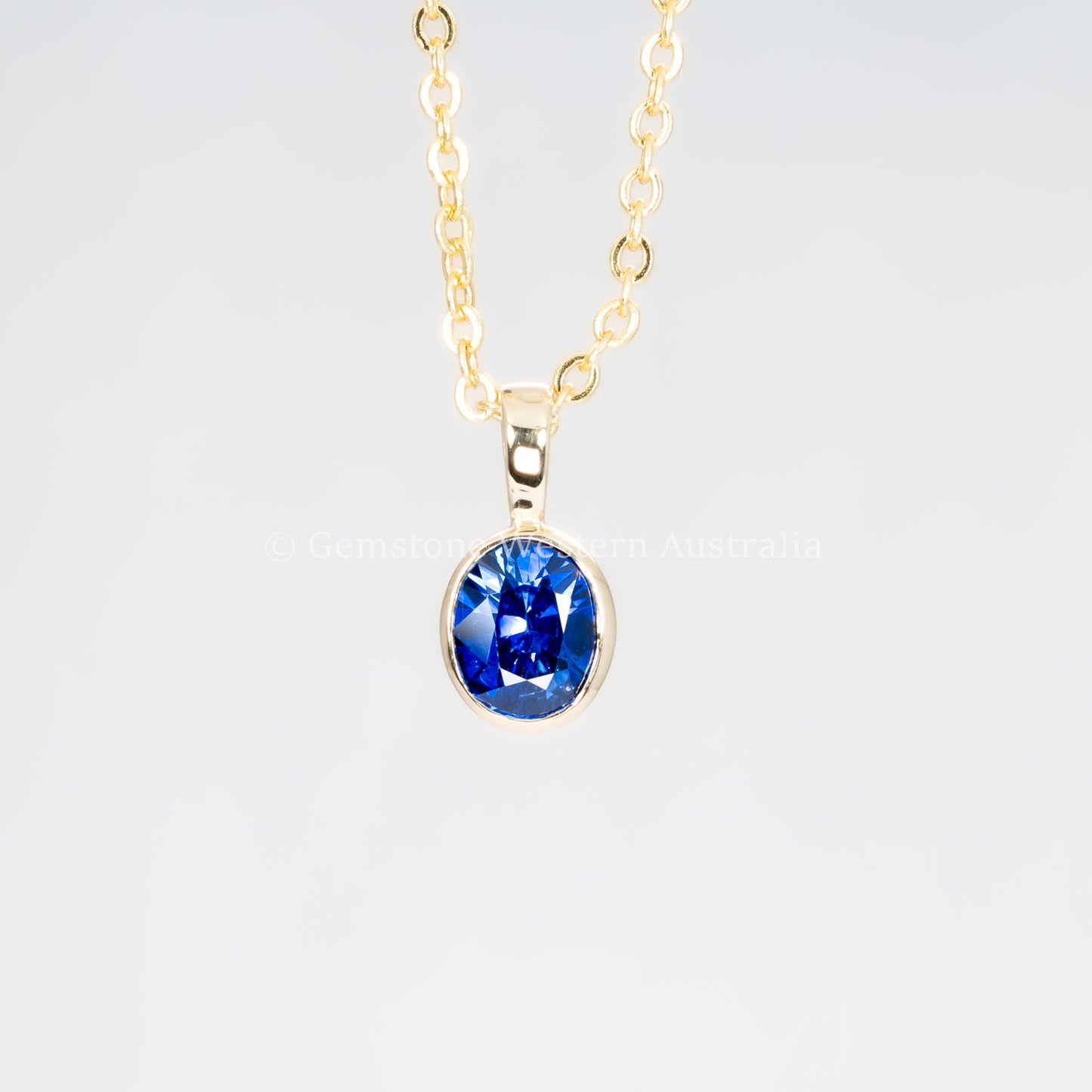 second front view of Royal Blue Sapphire Pendant in 18K Yellow Gold in neutral background
