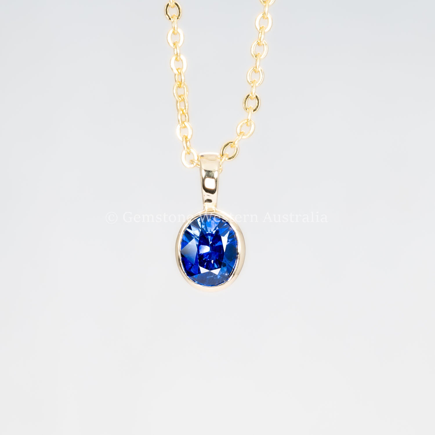 second front view of Royal Blue Sapphire Pendant in 18K Yellow Gold in neutral background