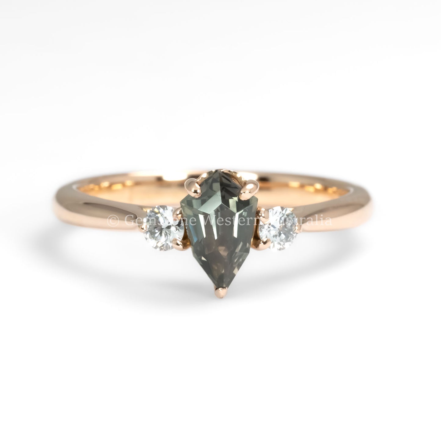 front view of Shield Cut Teal Sapphire Three stone Ring in 18K Rose Gold in white background