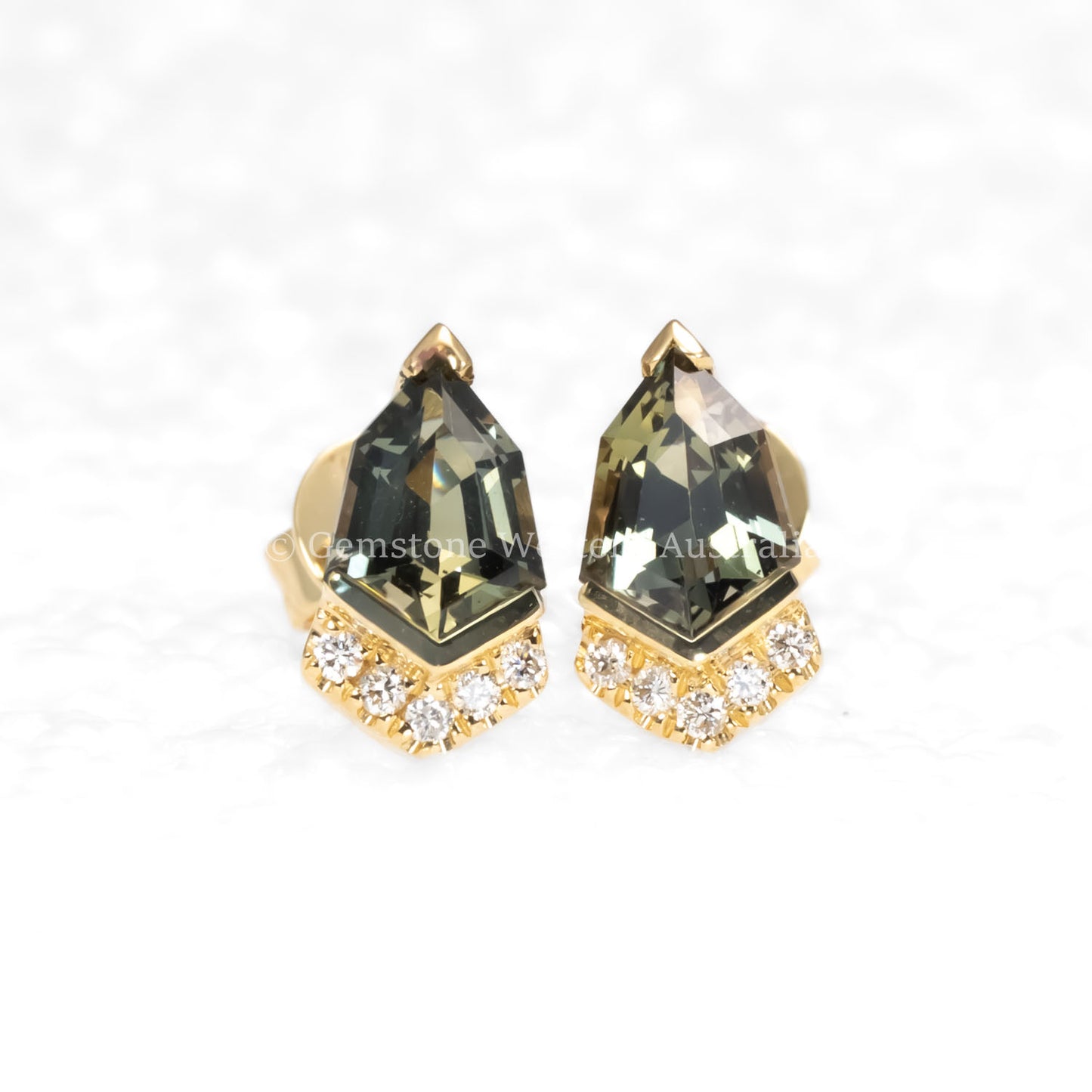 front view of Shield Cut Teal Sapphire Diamond Stud Earrings in 18K Yellow Gold in neutral background