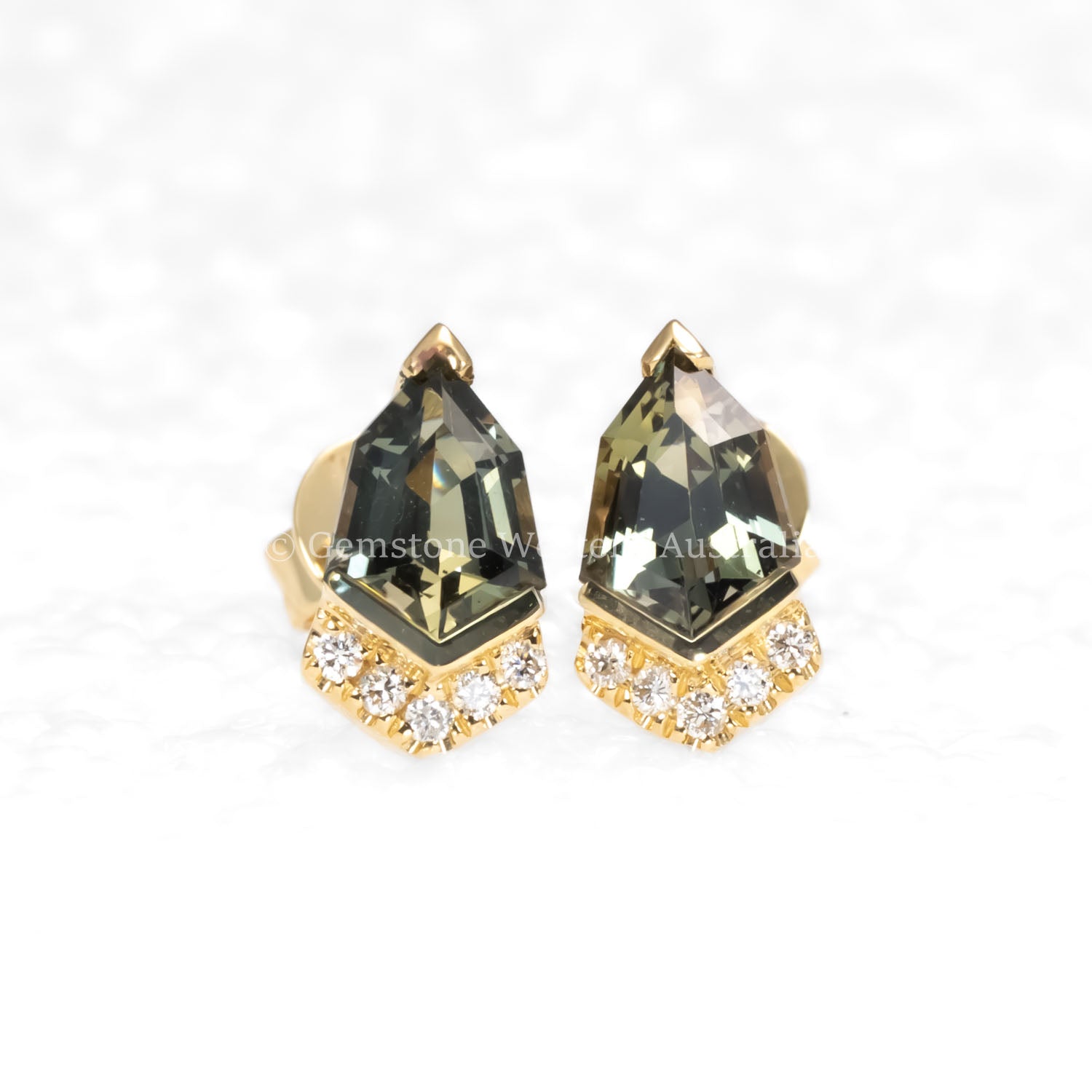 front view of Shield Cut Teal Sapphire Diamond Stud Earrings in 18K Yellow Gold in neutral background