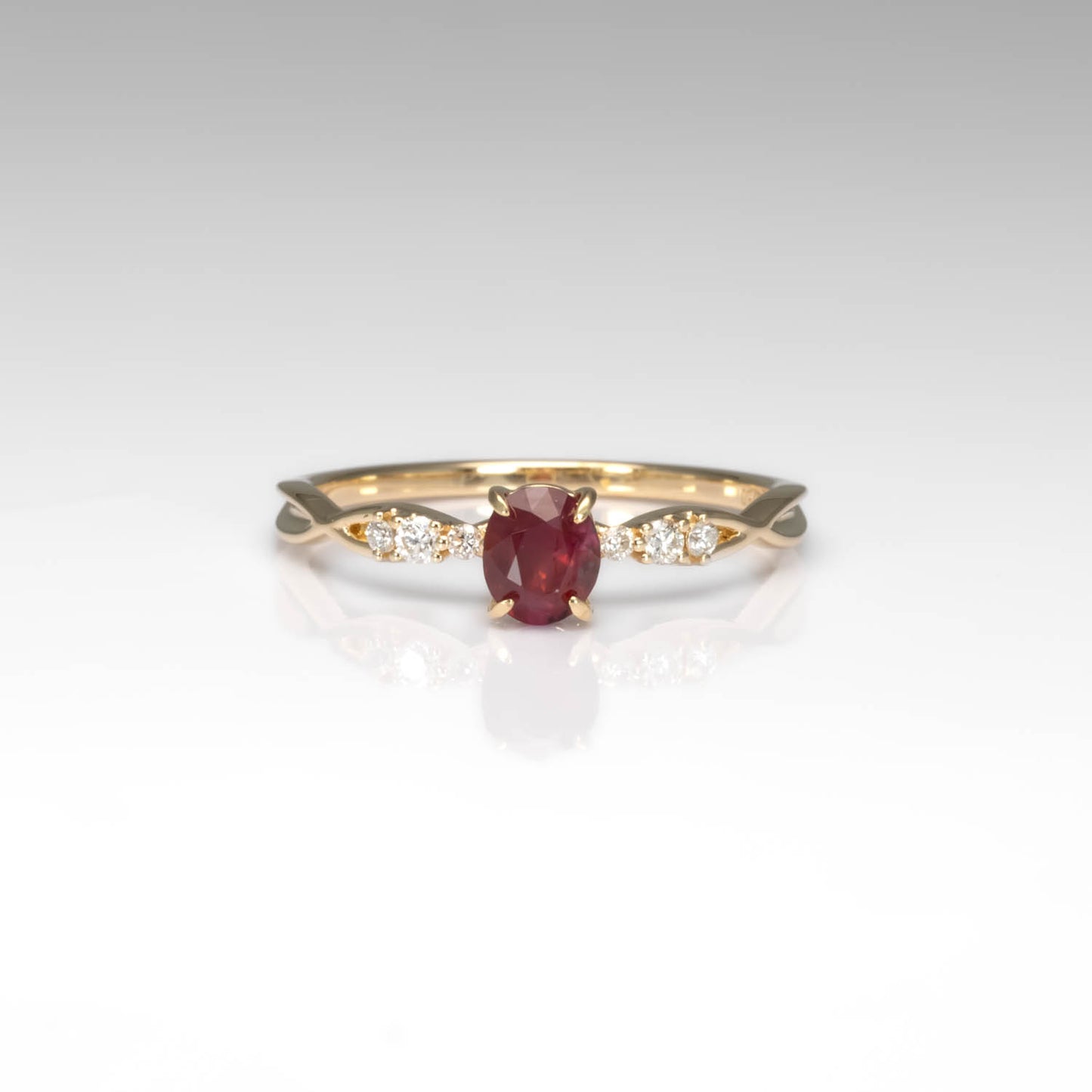 front view of a Natural Ruby & Diamond Twisted Band Ring in 18K Yellow Gold in neutral background