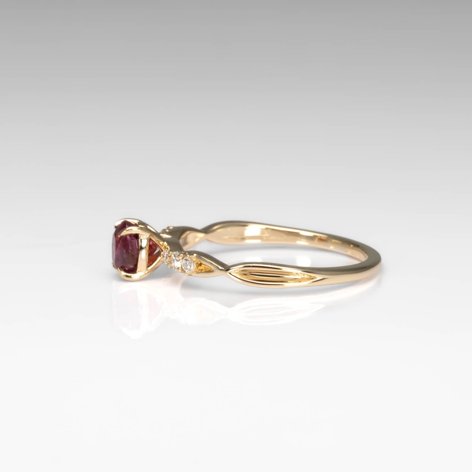 sideview of a Natural Ruby & Diamond Twisted Band Ring in 18K Yellow Gold in neutral background