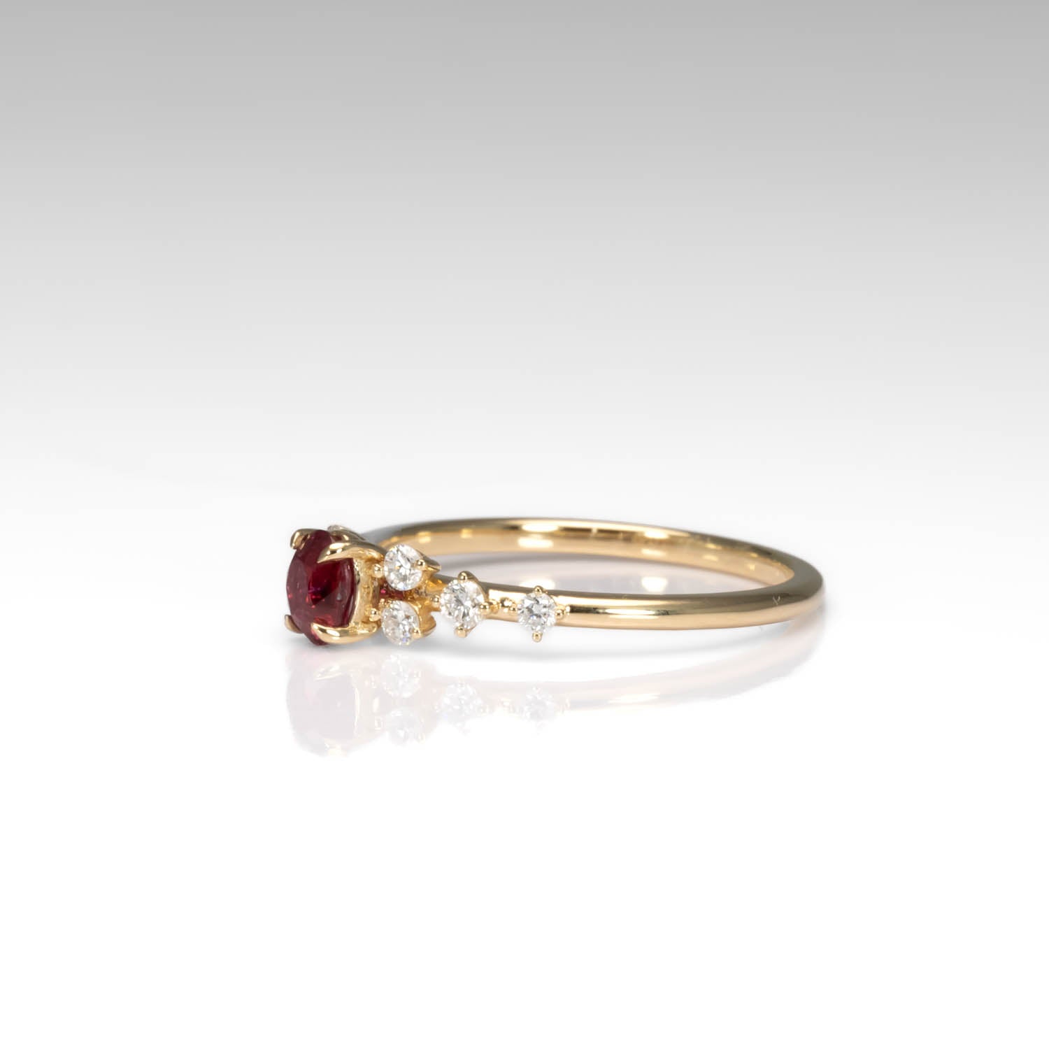 side view of a Natural Ruby & Diamond Ring in 18K Yellow Gold in neutral background
