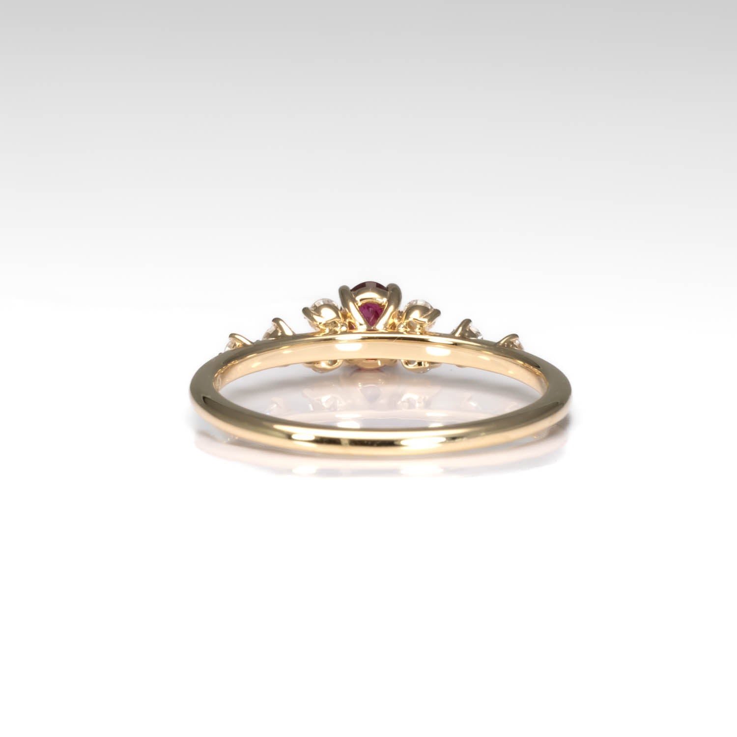 back view of a Natural Ruby & Diamond Ring in 18K Yellow Gold in neutral background