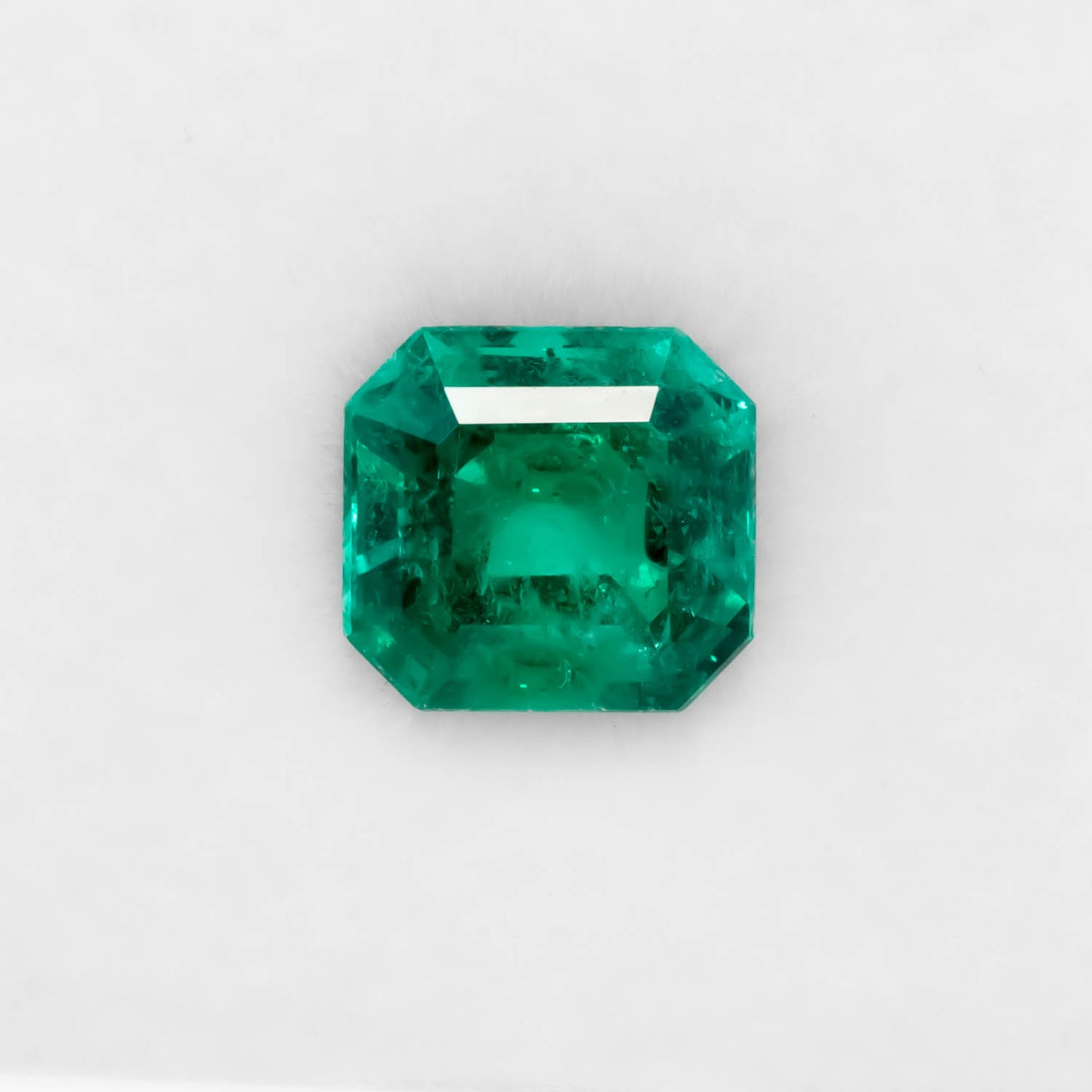Front view of 1.67CT Natural Colombian Emerald – Emerald Cut Vivid Green Gemstone in white background.