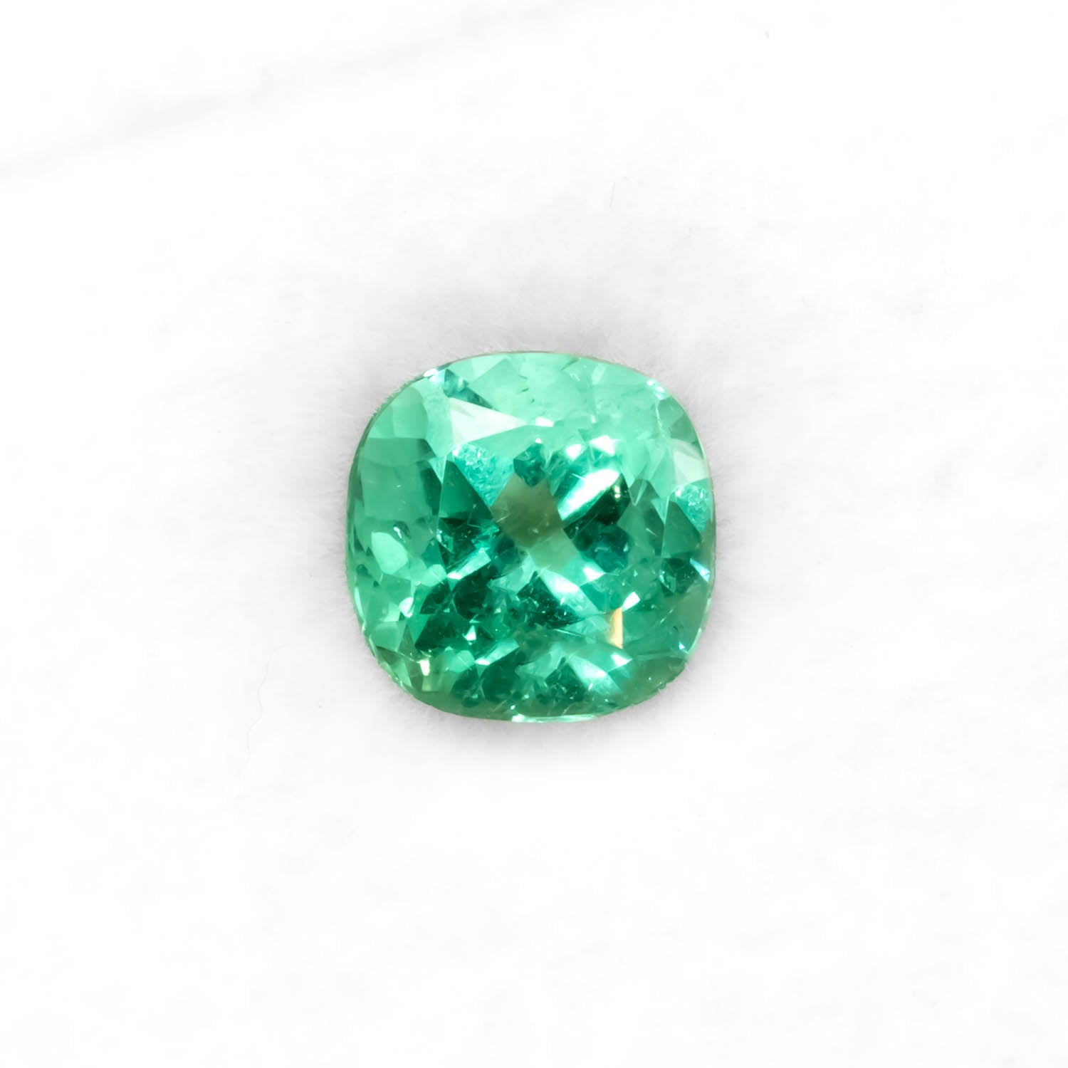 Front view of 1.84CT Natural Colombian Emerald – Cushion Cut Vivid Green Gemstone in white background.