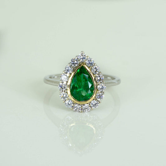 Bezel Set Emerald in a Diamond Halo Ring in 18K Gold