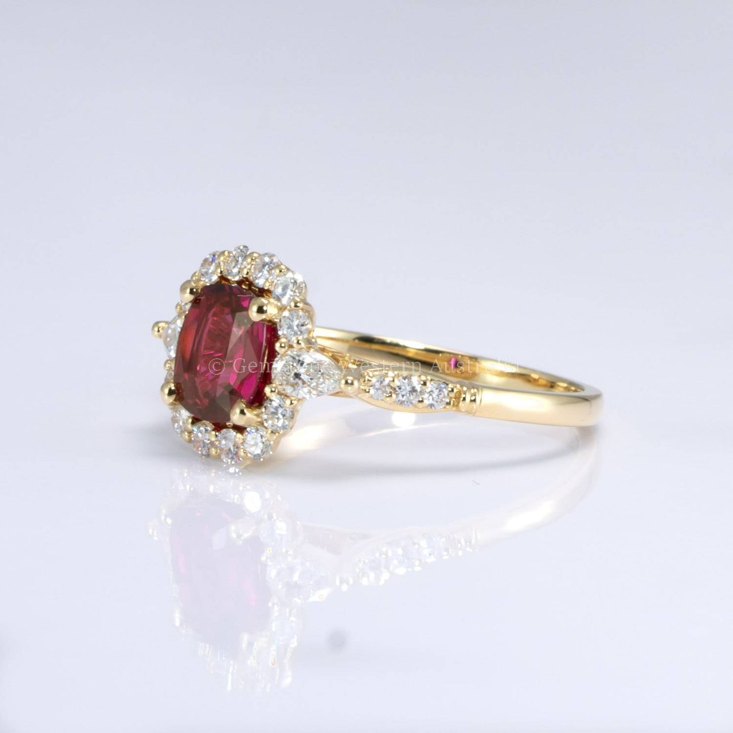 Natural Ruby Ring with Pear-Shaped Diamonds and Halo of Round Diamonds in 18K Yellow Gold | Natural Gemstone Jewellery