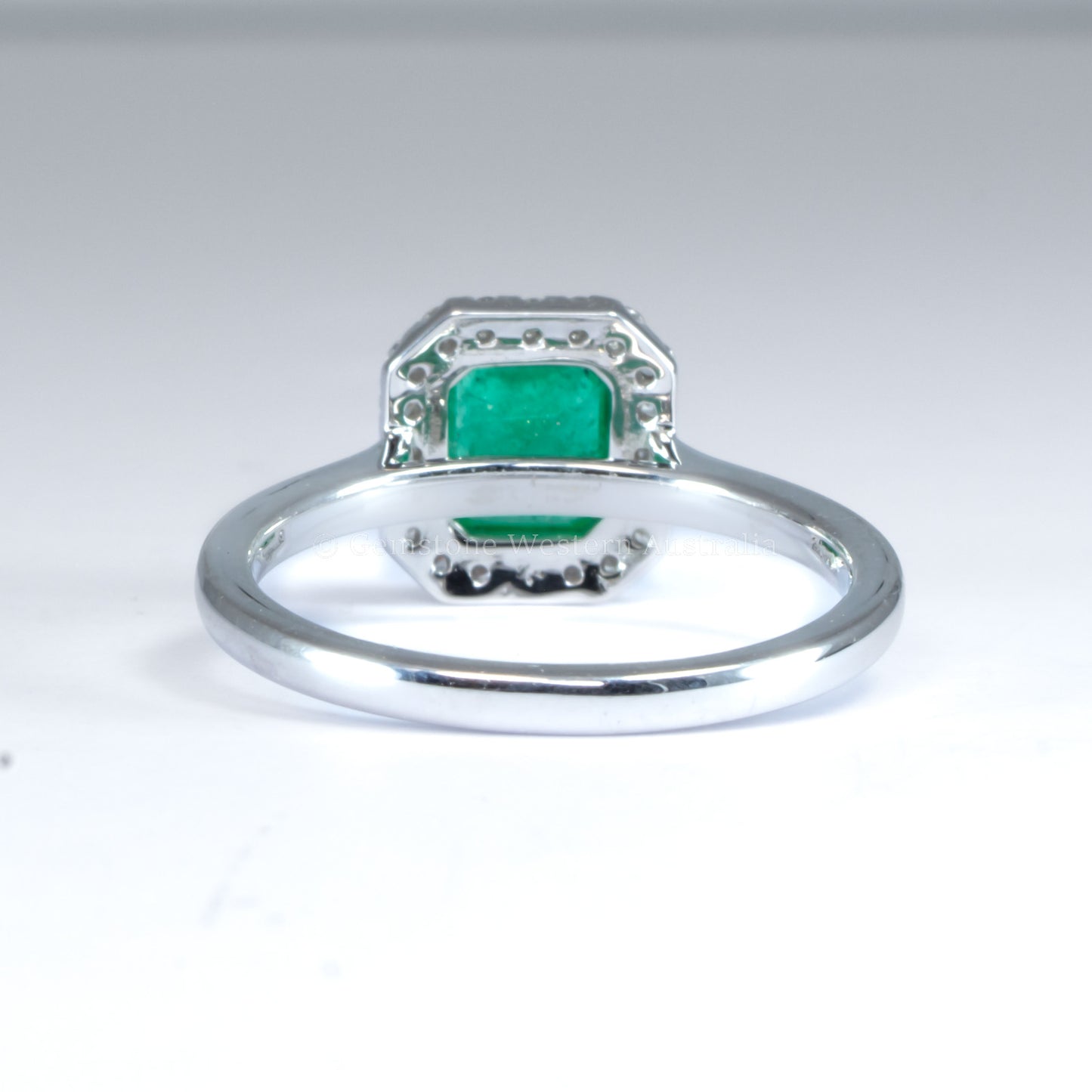 Emerald Cut Colombian Emerald Ring with Diamond Halo in Platinum