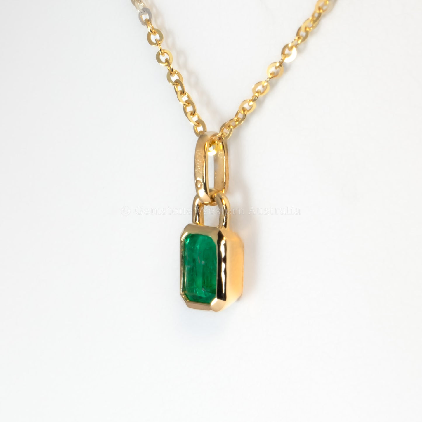 side view of 0.41ct Colombian Emerald Pendant in white background