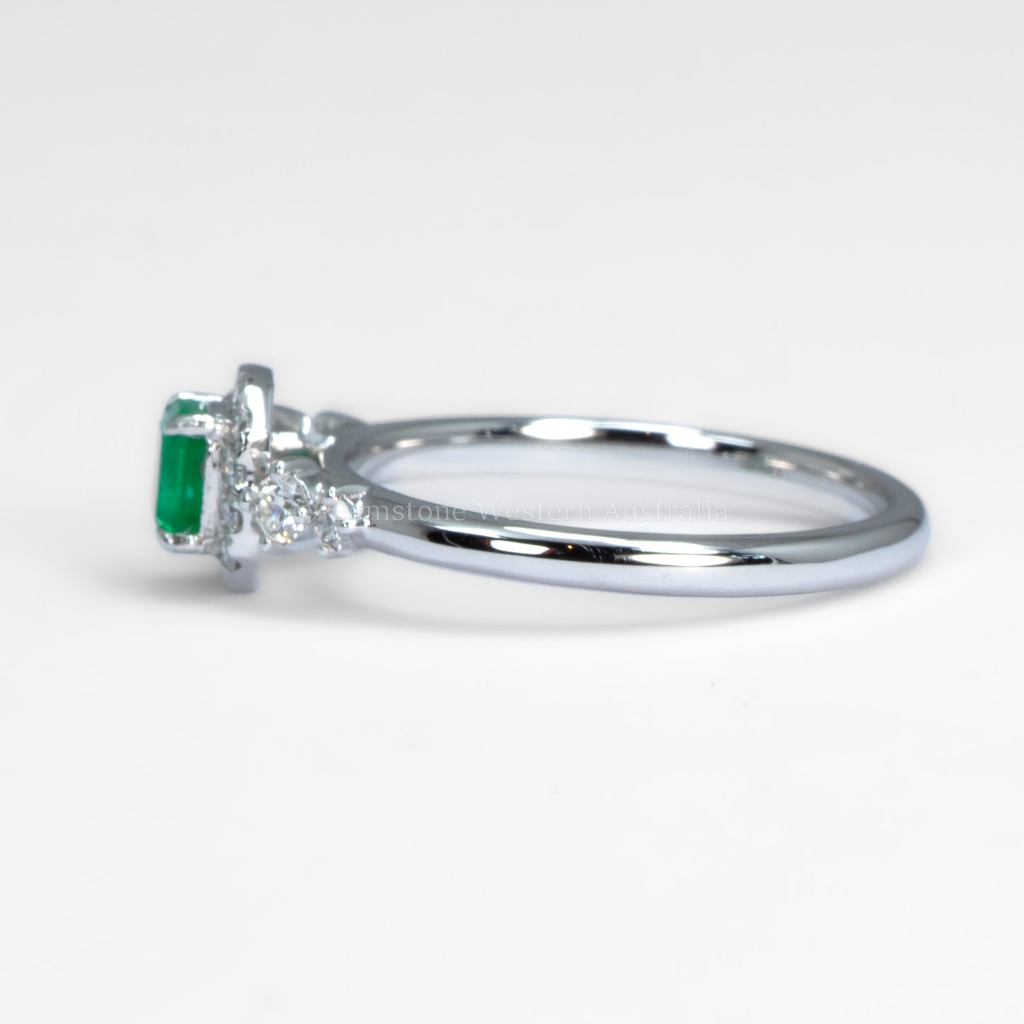 Platinum Ring with Emerald Cut Colombian Emerald and Diamond Halo