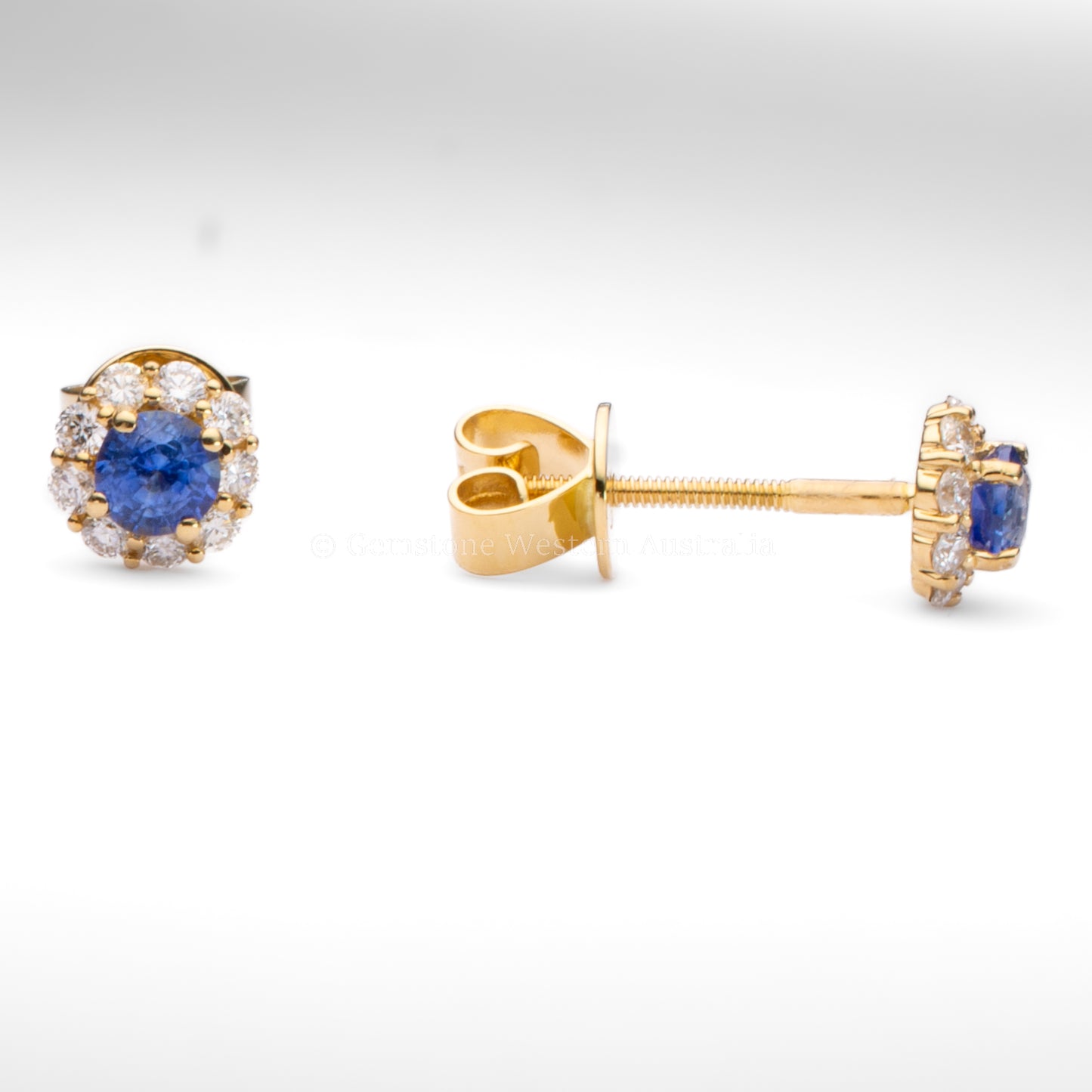 Gold earrings with blue gemstones on a white background