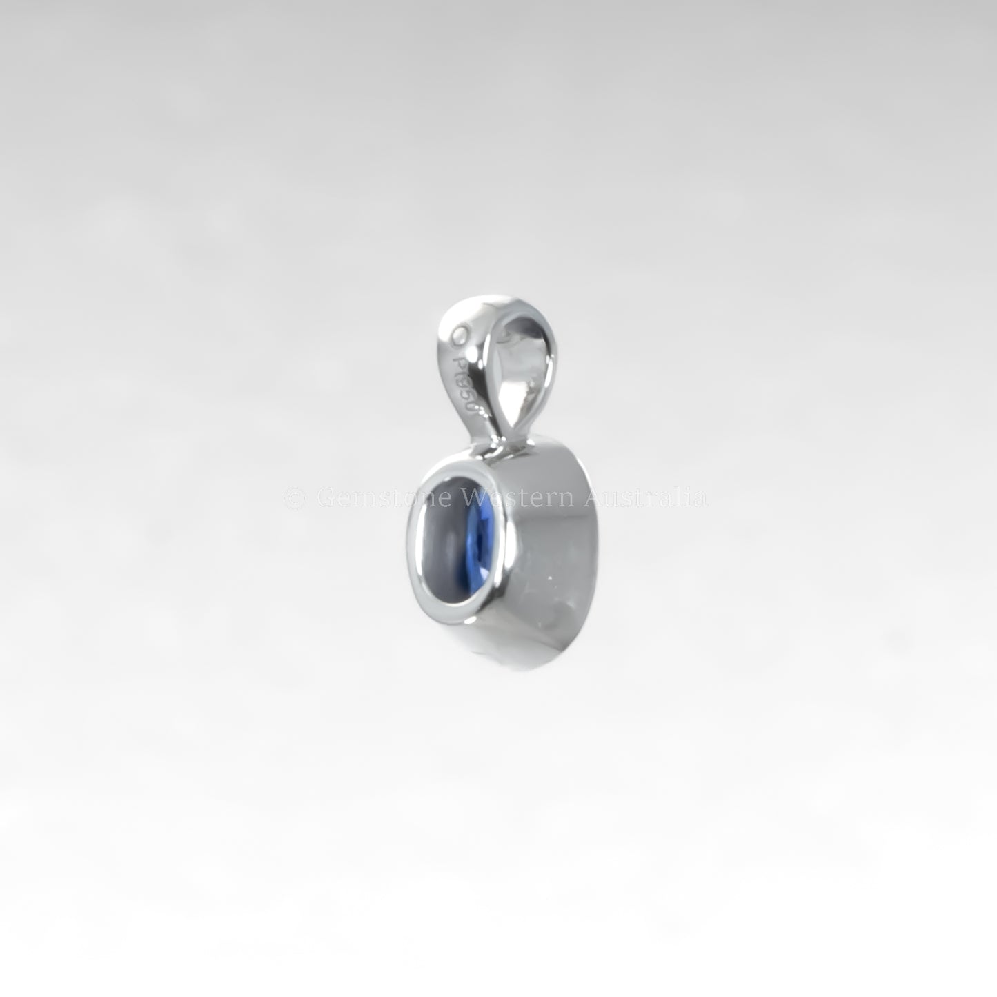 Silver pendant with a blue gemstone on a light gray background