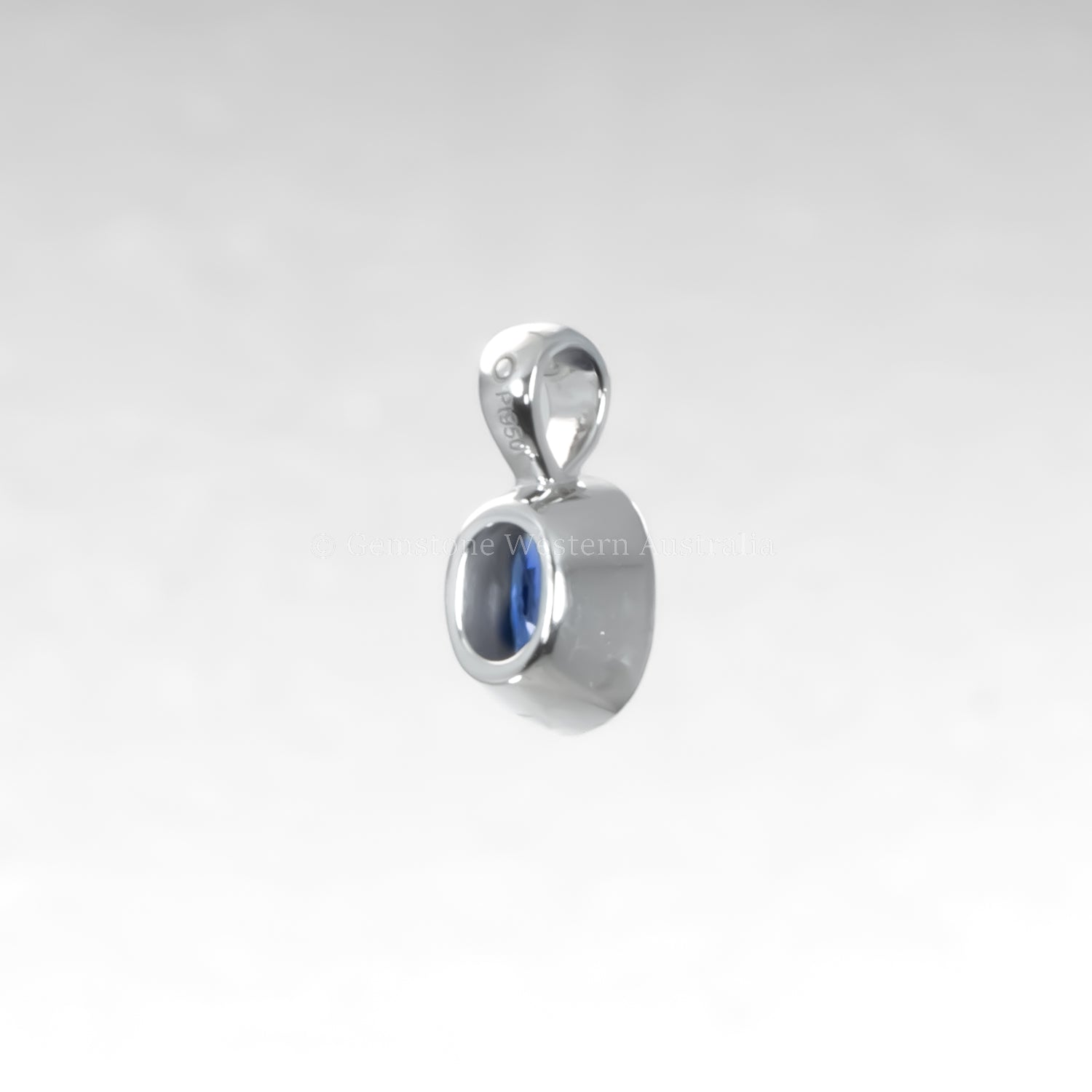 Silver pendant with a blue gemstone on a light gray background