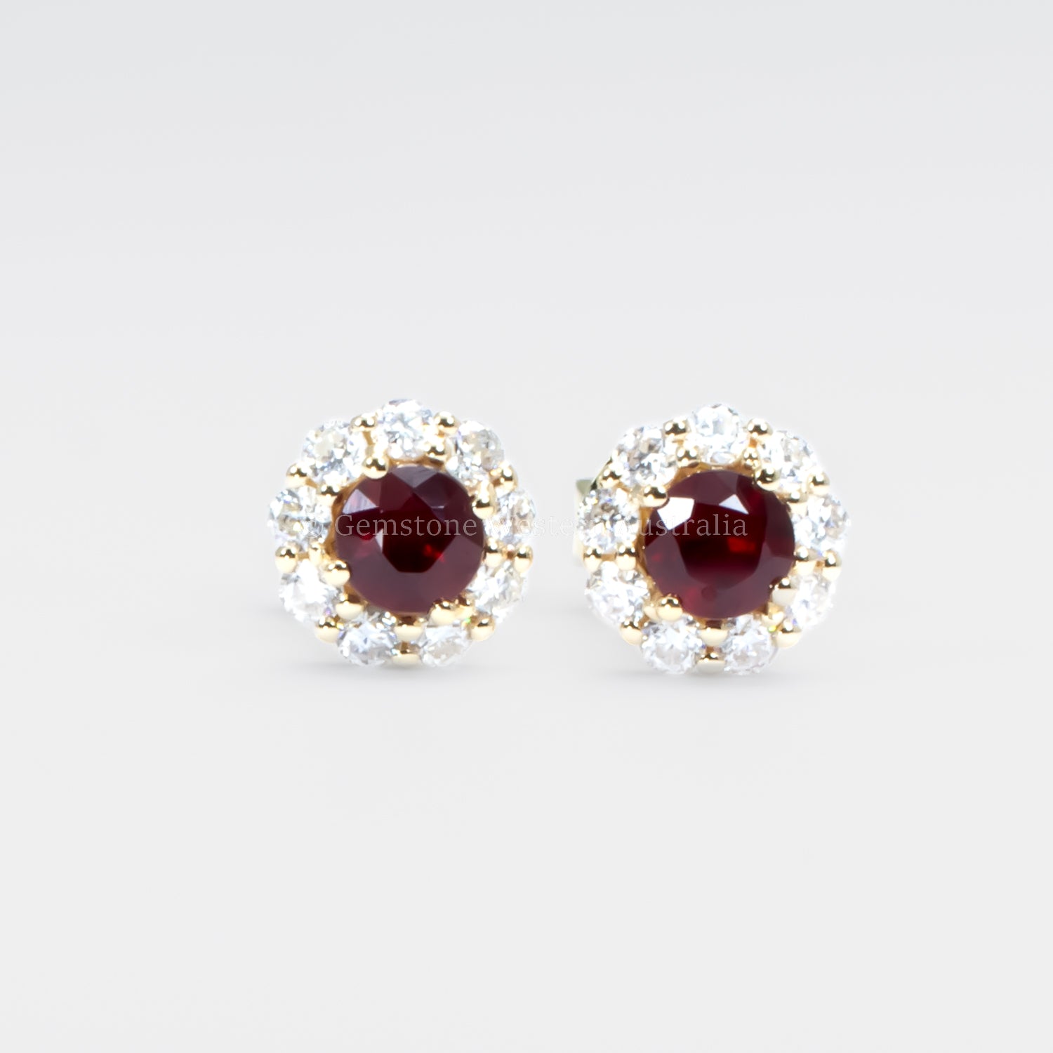 front view of ruby studs in grey background
