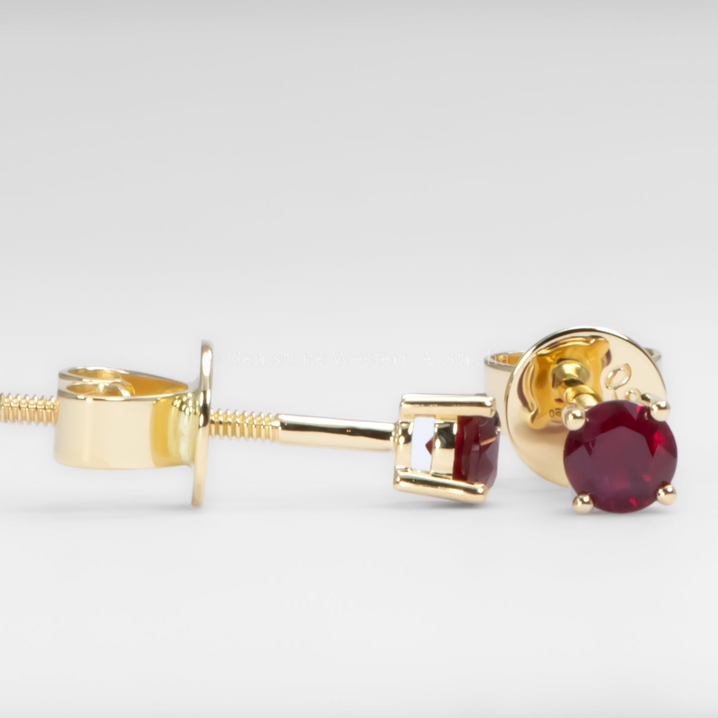 contrast of side and front view of 18K Gold earrings with ruby gemstones on a white background