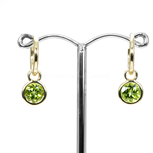 front view of peridot earrings in yellow gold